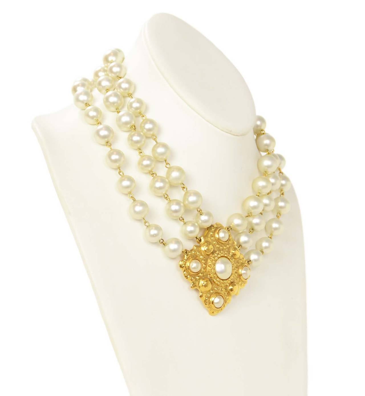 Chanel Vintage '86 3 Strand Pearl Choker w/Gold & Pearl Pendant
Features gold CC charm detail at necklace closure

    Made in: France
    Year of Production: 1986
    Stamp: 2 CC 3
    Closure: Jump ring clasp
    Color: Gold and ivory
   