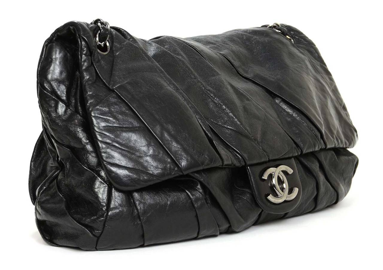 CHANEL Black Leather Pleated XL Maxi Flap Bag w/ Ruthenium Hardware

    Made in: Italy
    Year of Production: 2008
    Color: Black
    Hardware: Silvertone hardware
    Materials: Distressed smooth leather
    Lining: Black satin lining
 