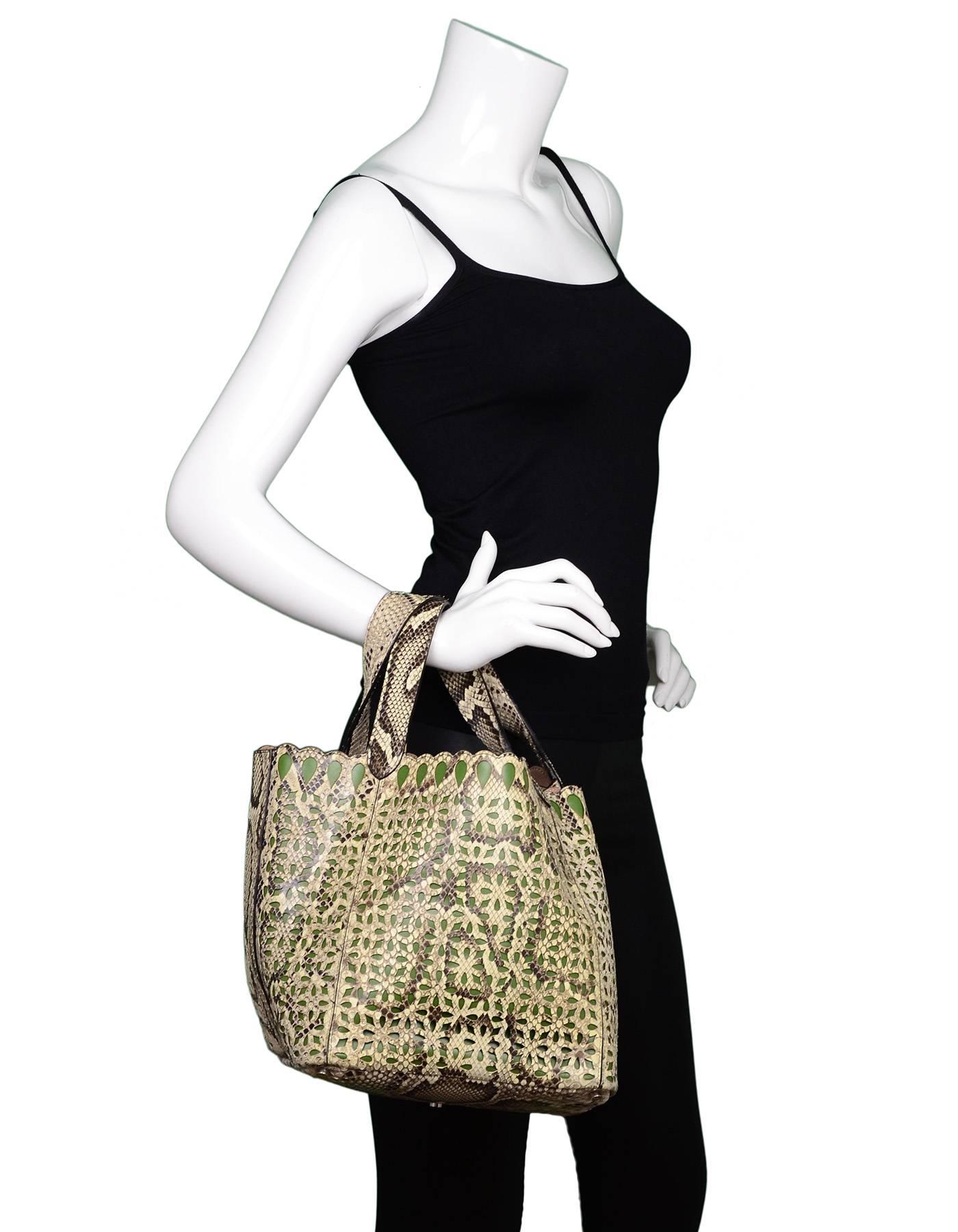 Alaia Beige & Green Python Laser-Cut Tote

Made In: Italy
Color: Beige, green
Hardware: Silvertone
Materials: Python, leather
Lining: Nude leather
Closure/opening: Open top
Exterior Pockets: None
Interior Pockets: None

Retail Price: $3,500