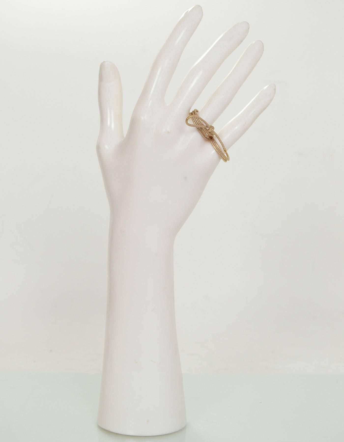 Christian Dior Miss Dior Two Finger Bow Ring Sz M

Color: Goldtone
Materials: Metal
Stamp: Dior
Overall Condition: Excellent pre-owned condition 
Included: Christian Dior box and dust bag

Size: Medium, Sz 7 and 6.5