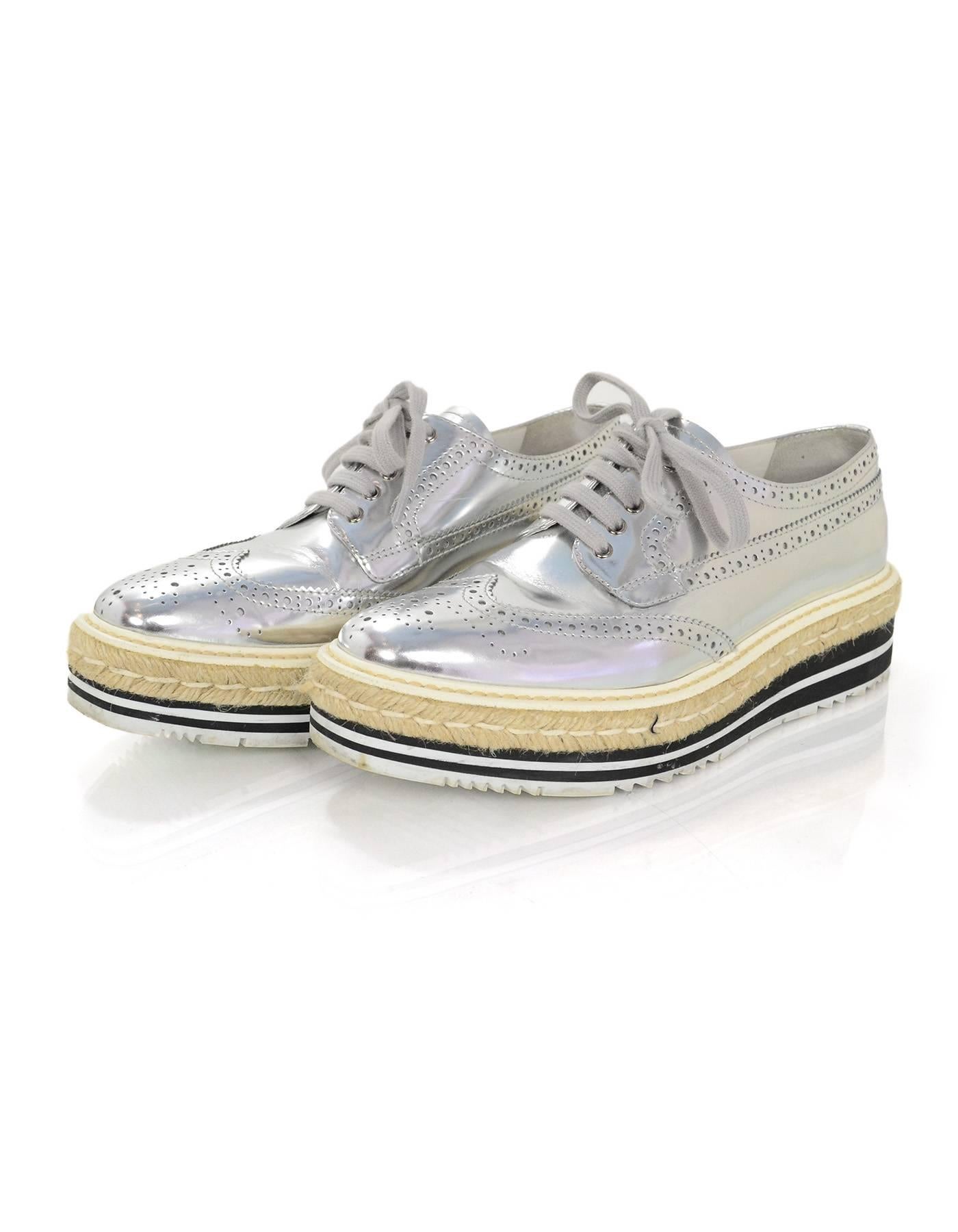 Prada Silver Perforated Oxford Creeper Brogue Espadrilles Sz 38

Made In: Italy
Color: Silver
Materials: Leather, jute rope, rubber
Closure/Opening: Lace tie closure
Sole Stamp: Prada
Retail Price: $950 + tax
Overall Condition: Excellent pre-owned