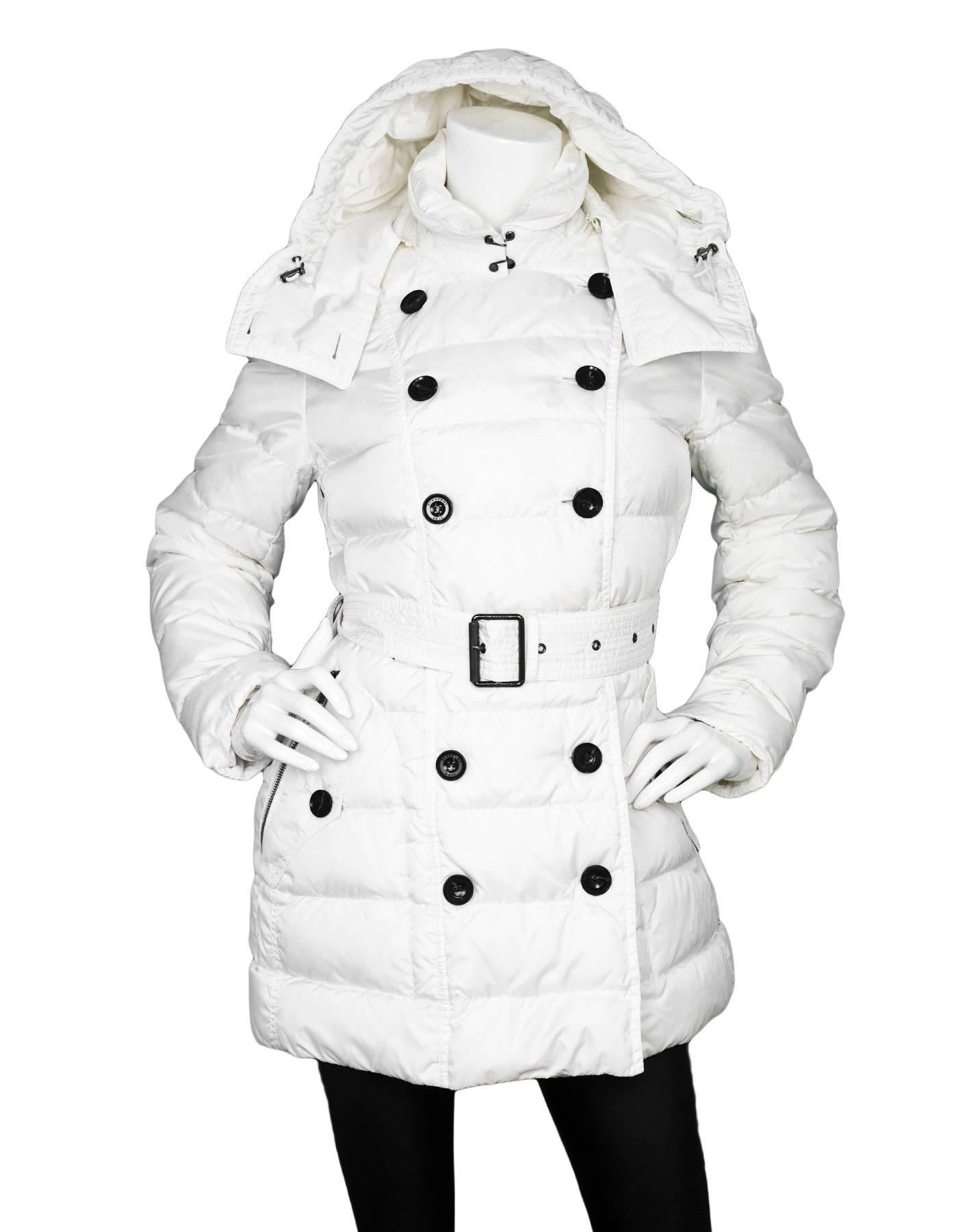 Burberry Brit White Puffer Coat 
Features optional waist belt

Made In: China
Color: White
Composition: 100% Nylon
Lining: Nova plaid, 100% polyester
Closure/Opening: Zip up front with double breasted button down closure
Exterior Pockets: Four hip