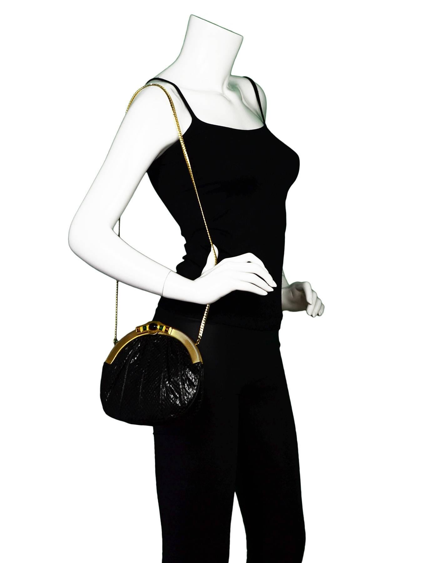 Judith Leiber Black Vintage Python Evening Bag

Color: Black
Hardware: Goldtone
Materials: Python, metal
Lining: Black satin
Closure/Opening: Frame top with snap closure
Exterior Pockets: None
Interior Pockets: Two flat pockets
Overall Condition: