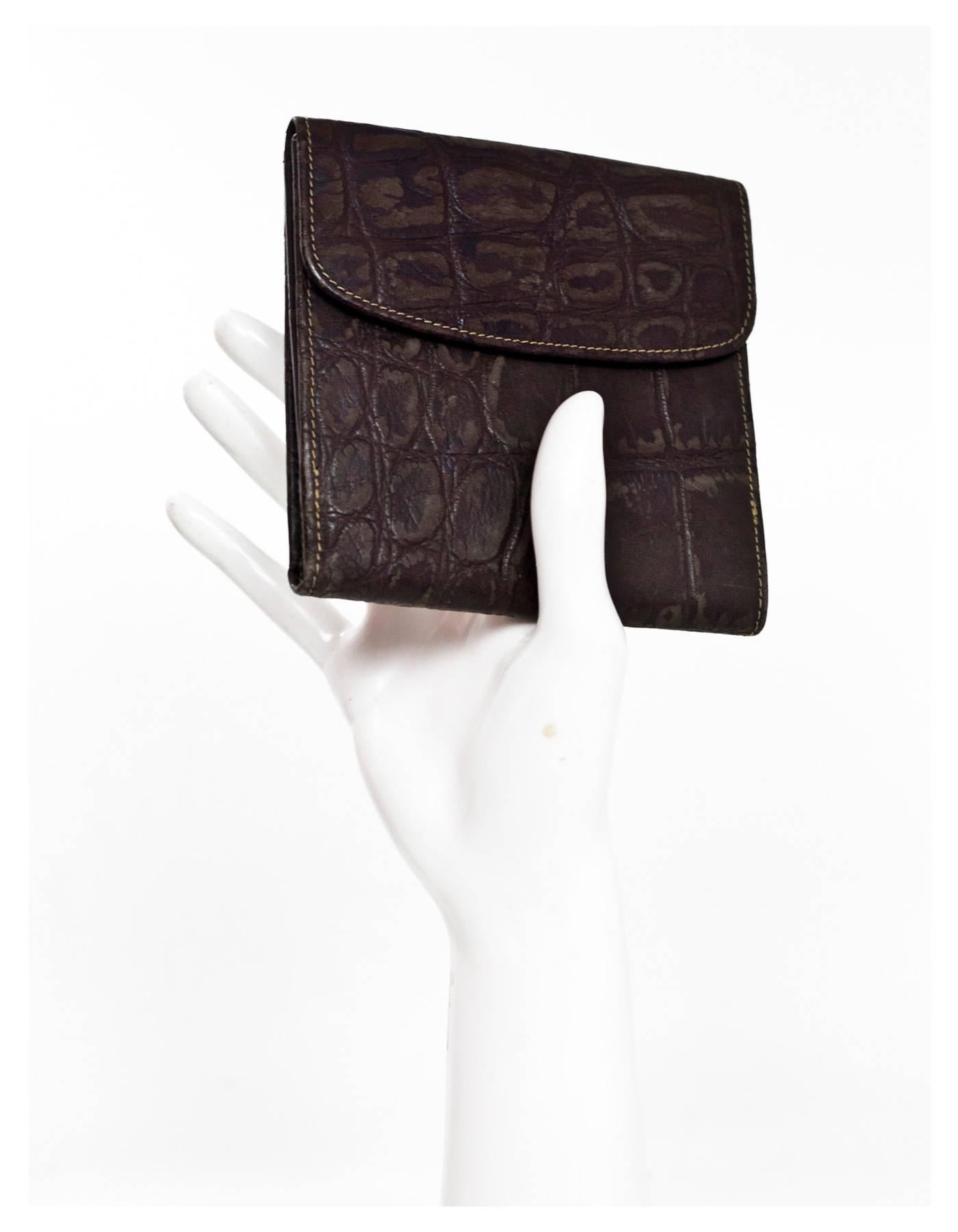 Fendi Vintage Brown Embossed Distressed Leather Wallet
Features embossed crocodile print

Made In: Italy
Color: Brown
Materials: Distressed leather
Lining: Embossed leather
Closure/Opening: Side snap closure
Exterior Pockets: None
Interior Pockets:
