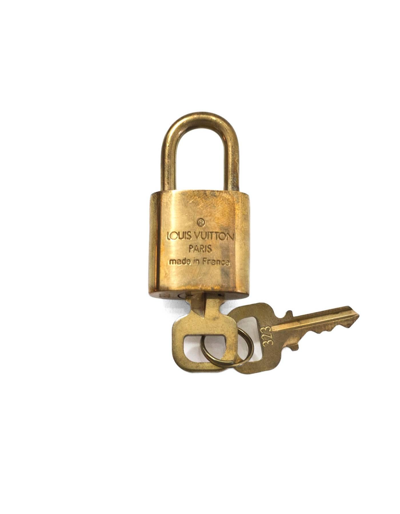 Louis Vuitton Goldtone Lock & Keys

Made In: France
Color: Gold
Hardware: Goldtone
Materials: Metal
Stamp: Louis Vuiton Made in France 323
Overall Condition: Very good good pre-owned condition, light tarnish throughout
Includes: Lock, two