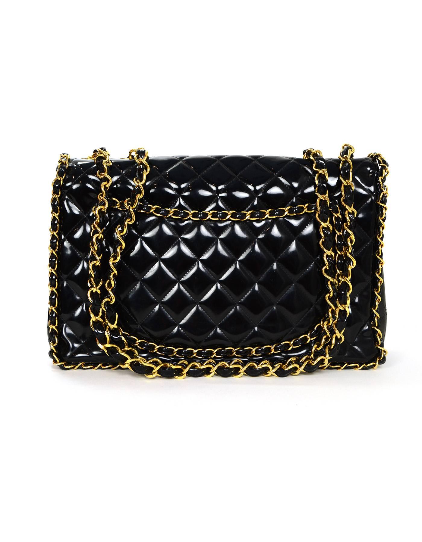 Chanel Vintage Black Patent Leather Chain Around Maxi Flap Bag.  Features classic CC twist lock and quilting with patent laced chain around border and back pocket of bag.  Strap can be worn doubled on the shoulder, or singled as a crossbody.

Made