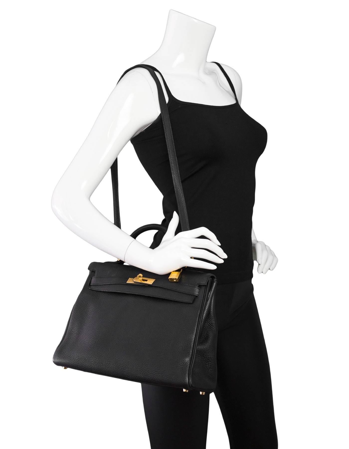 Hermes Black Togo 32cm Kelly Retourne Bag 
Features removable shoulder/crossbody strap

Made In: France
Year of Production: 2007
Color: Black
Hardware: Goldtone
Materials: Togo leather, metal
Lining: Black leather
Closure/opening: Flap top with two