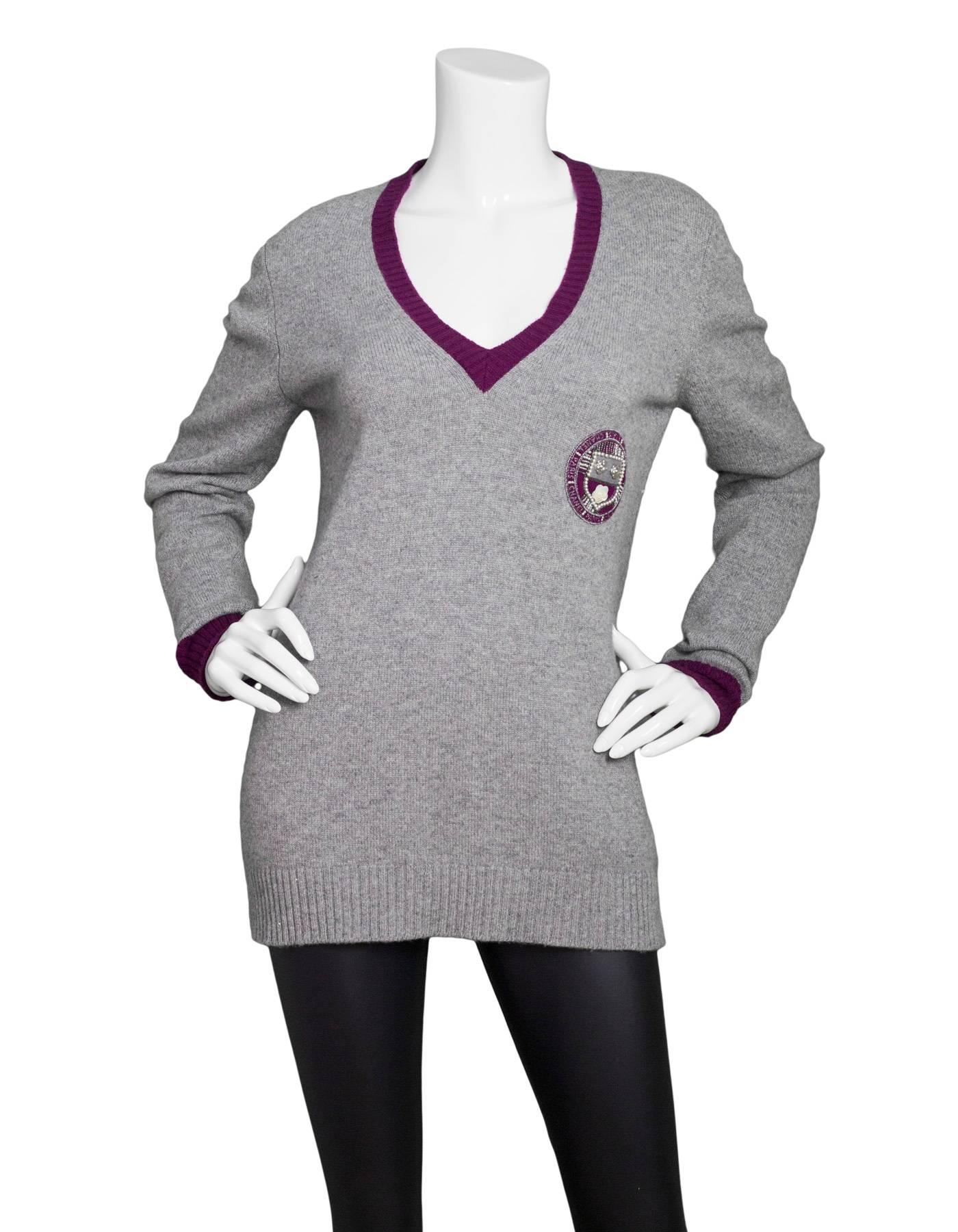 Chanel Grey Cashmere Prep-School Sweater
Features Burgundy trim & circular Chanel crest with sequin details

Made In: United Kingdom
Color: Grey and burgundy
Materials: 100% cashmere
Lining: None
Closure/Opening: Pull over
Exterior Pockets: