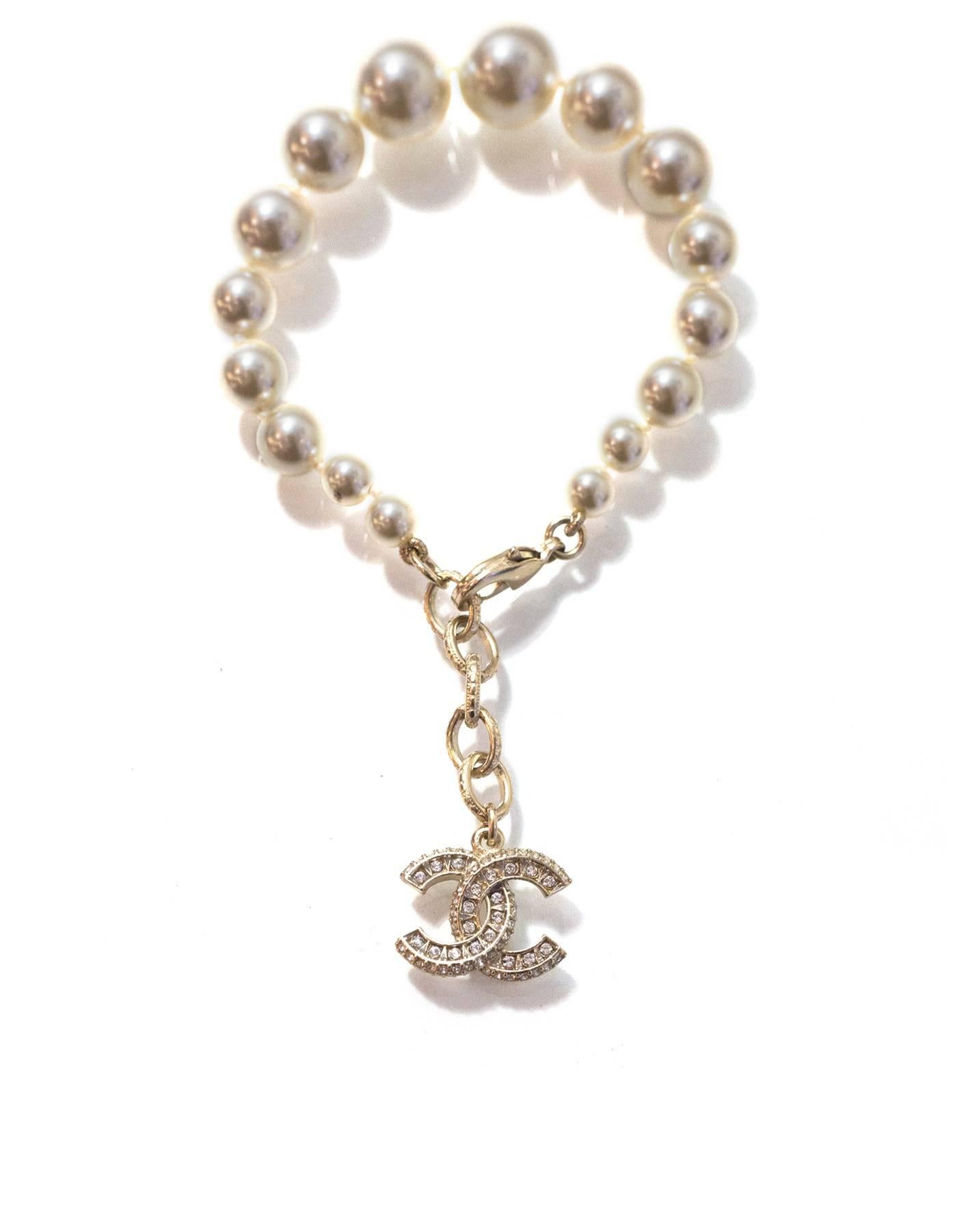 Chanel Graduated Pearl & Crystal CC Pendant Bracelet

Made In: France
Year of Production: 2016
Color: Pale goldtone and ivory
Materials: Faux pearl, metal and crystal
Closure/Opening: Lobster claw clasp
Stamp: P16 CC V
Overall Condition: