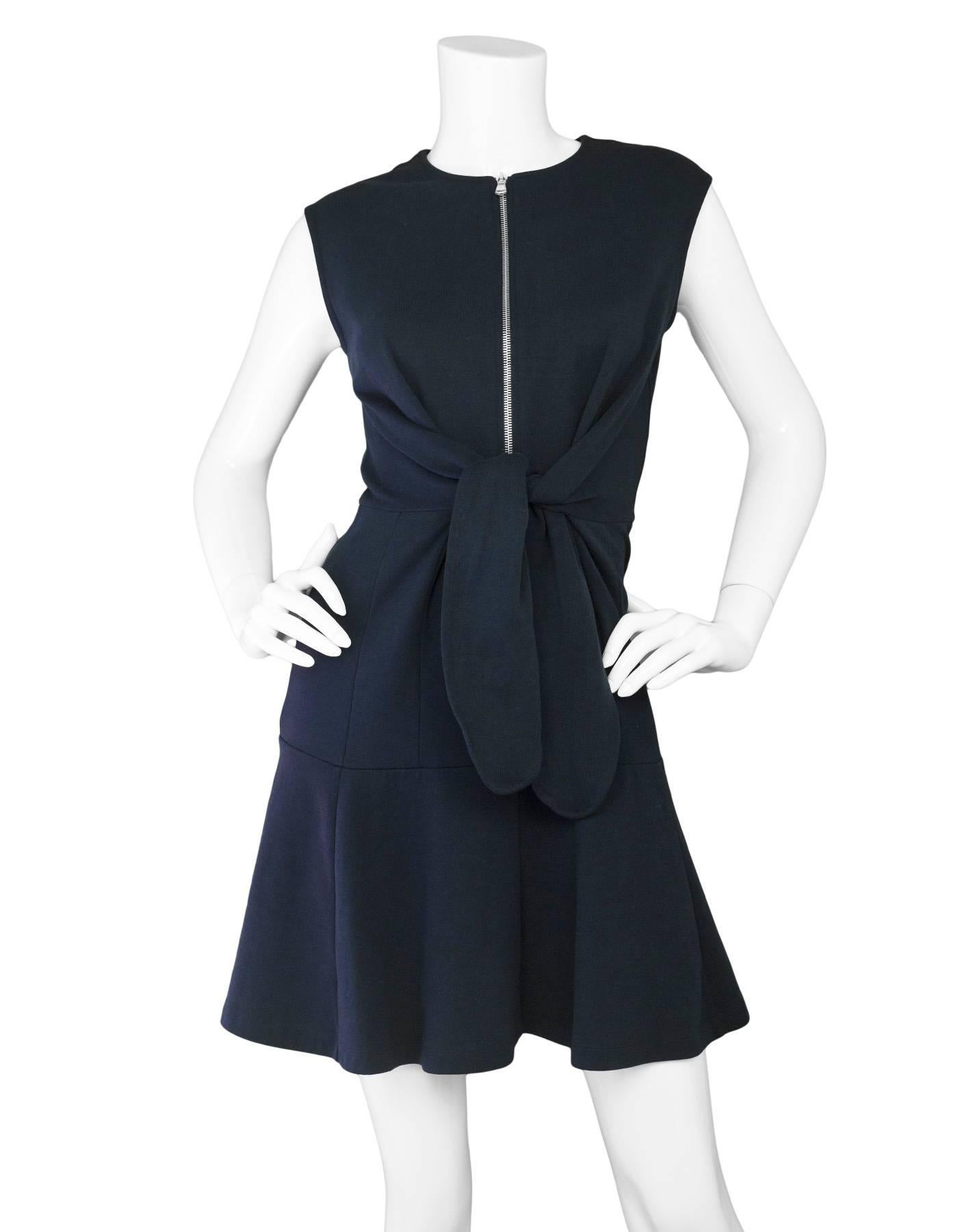 Carven Navy Sleeveless Zip Front Dress
Features Shirt Waist-Tie style front

Made In: Bulgaria
Color: Navy
Composition: 98% Cotton, 2% polyamide
Lining: None
Closure/Opening: Back center zip up and front zip up
Exterior Pockets: None
Interior