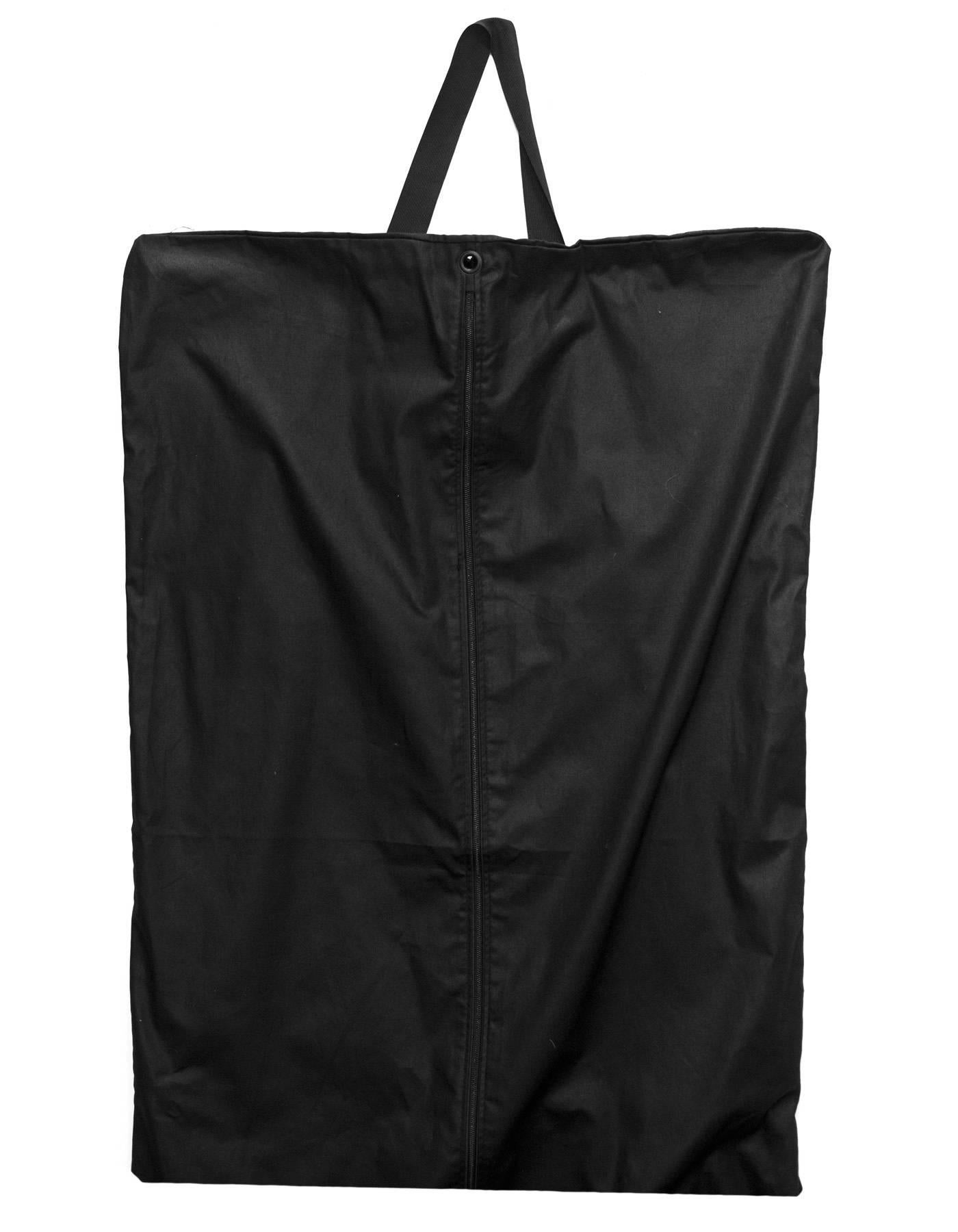 Saint Laurent Black Canvas Garment Bag & Hanger Set
Garment bag features two loops for folding and hanging 

Color: Black
Hardware: Silvertone
Materials: Canvas, plastic andmetal
Closure/Opening: Zip up center 
Overall Condition: Excellent