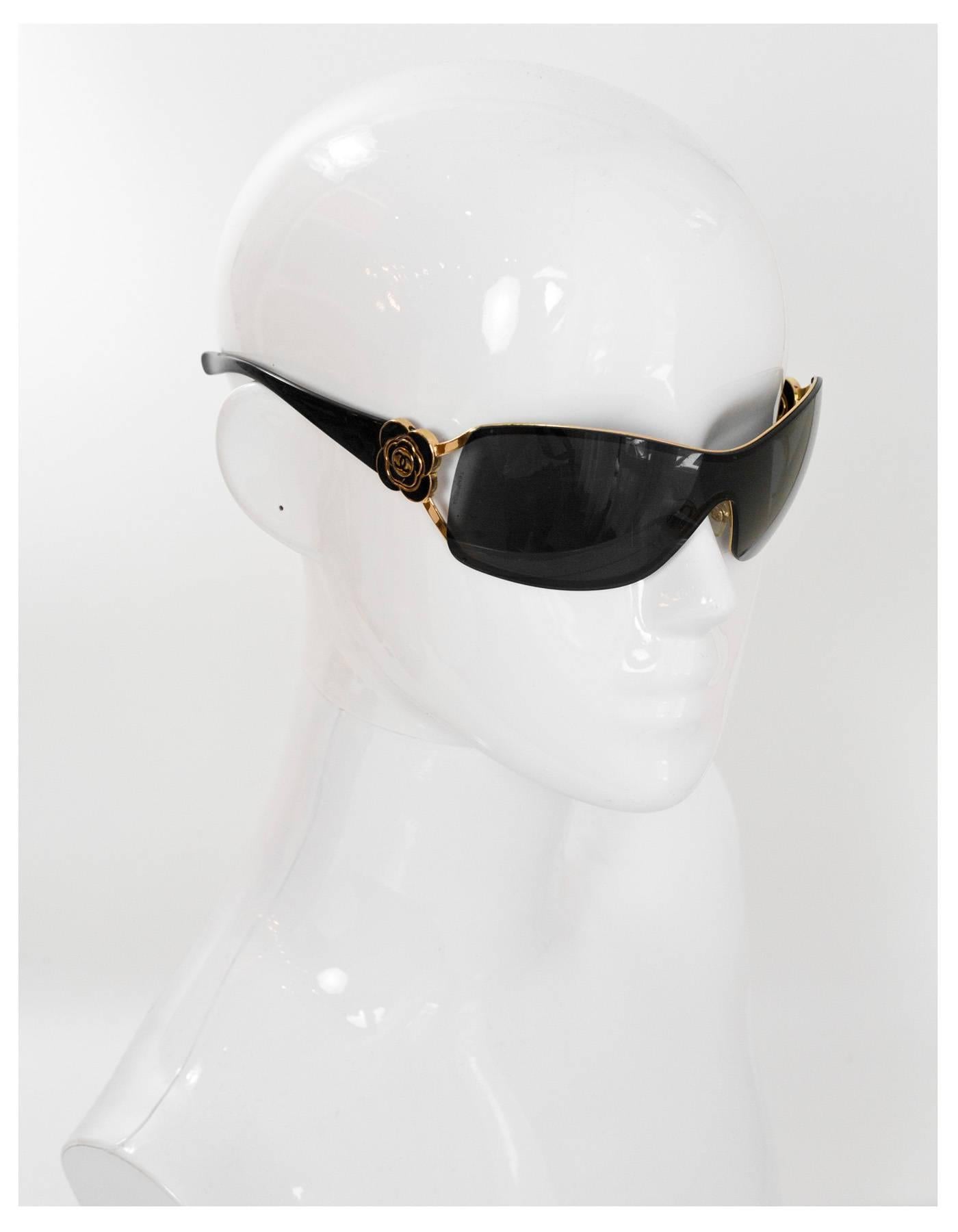 Chanel Black & Gold Shield Sunglasses with Camelia
Features signature camelia flower at arms

Color: Black and gold
Materials: Metal and resin
Overall Condition: Excellent pre-owned condition, minor surface marks
Includes: Chanel sunglasses