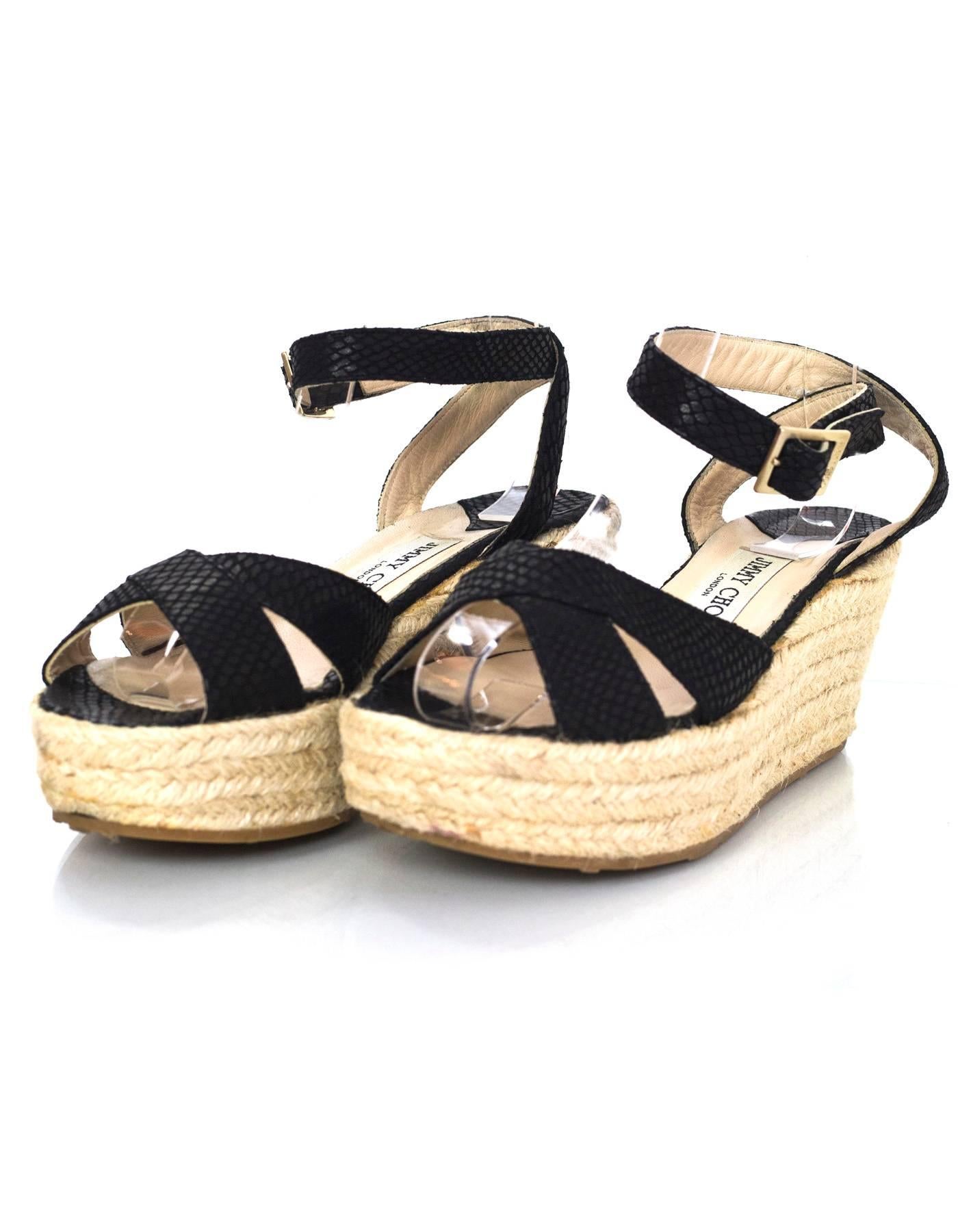Jimmy Choo Black Embossed Snakeskin Platform Sandals Sz 36

Made In: Italy
Color: Black, tan
Materials: Embossed leather, jute rope
Closure/Opening: Buckle closure at ankle
Sole Stamp: Jimmy Choo London Made in Italy 36
Overall Condition: Very good