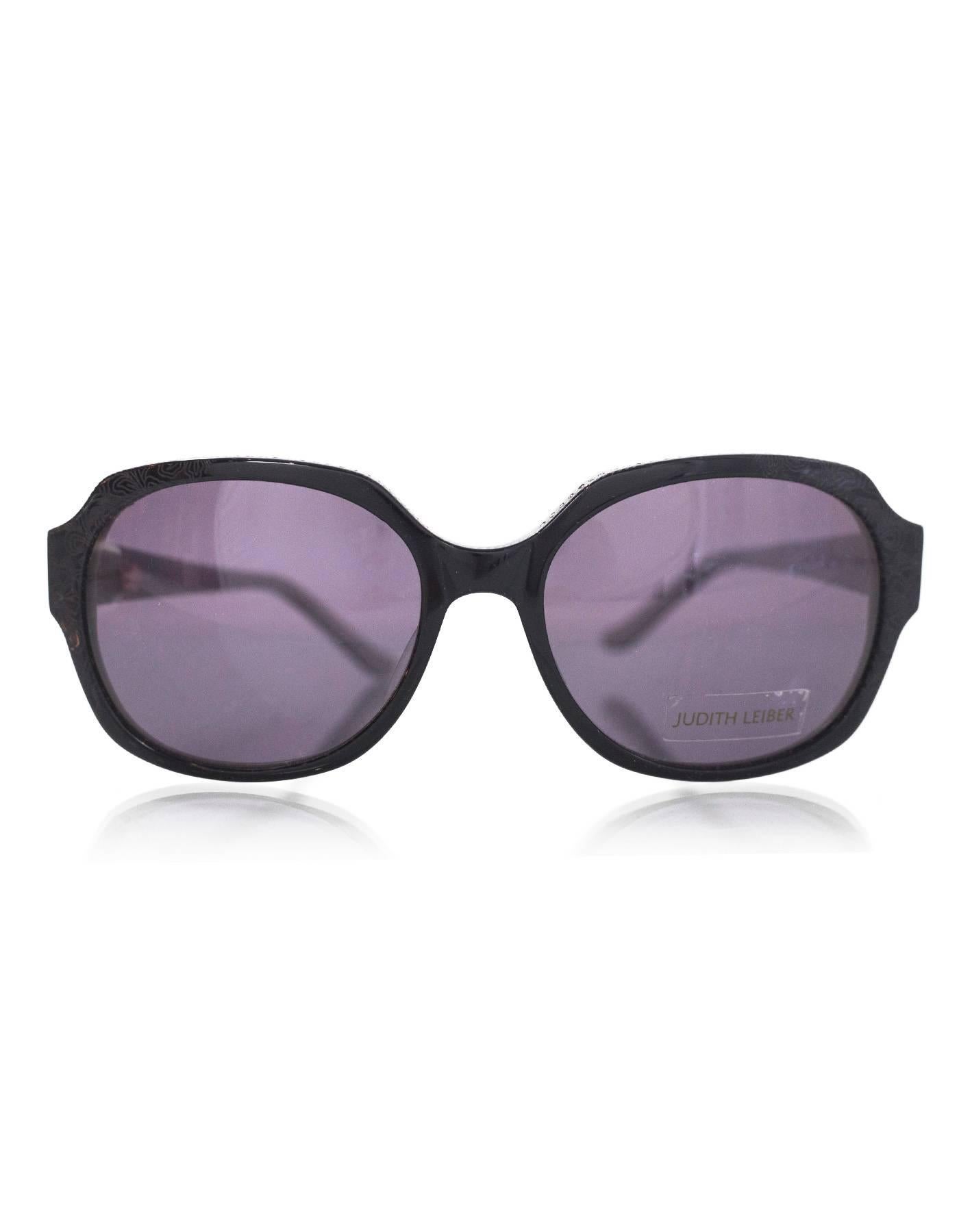 Judith Leiber Black Swarovski Crystal Sunglasses
Features crystals at top of frame and arms and floral laser-etched design

Made In: Japan
Color: Black
Materials: Resin, crystal
Retail Price: $420 + tax
Overall Condition: Excellent pre-owned