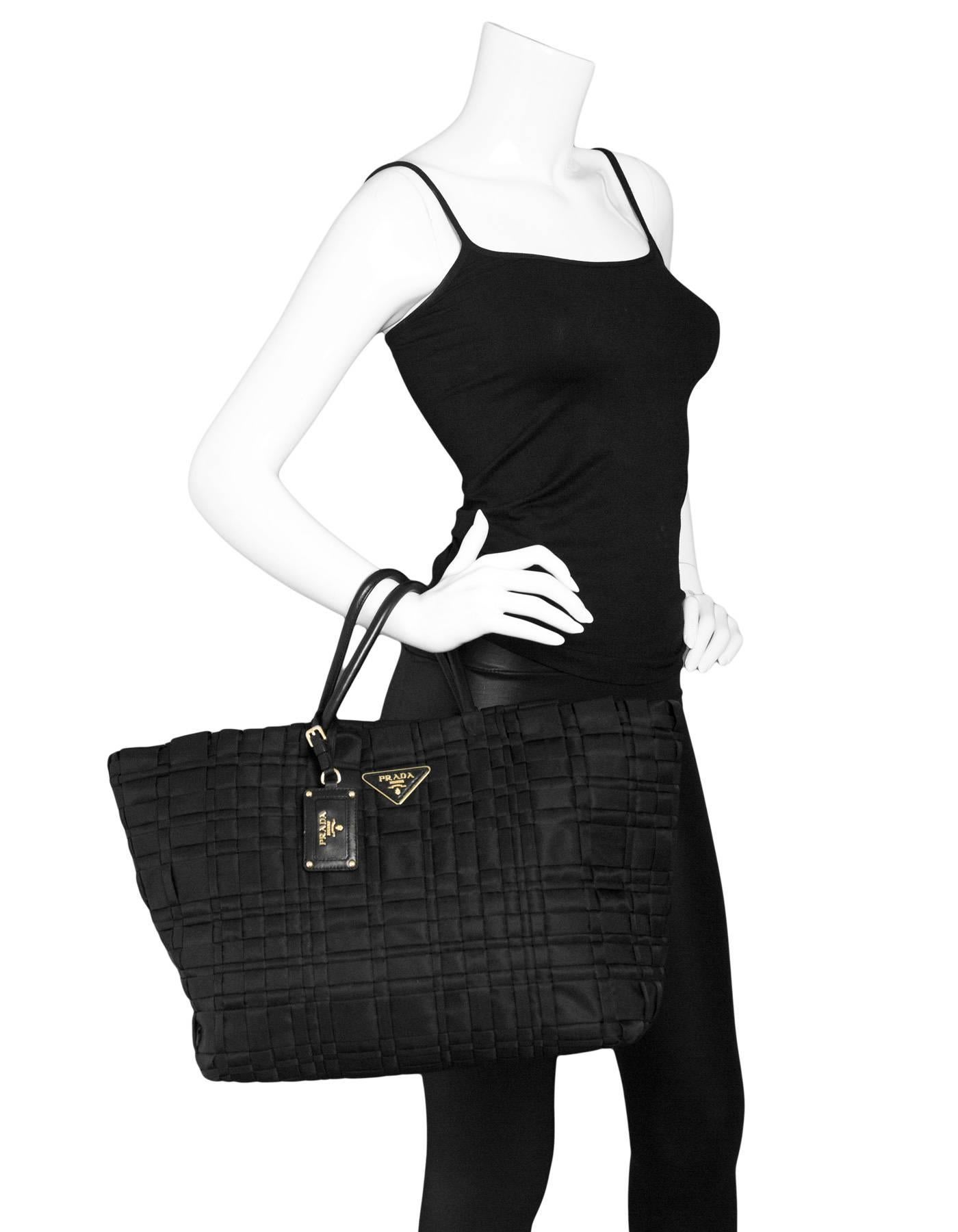 Prada Black Tessuto Woven Tote Bag

Made In: Italy
Color: Black
Materials: Tessuto nylon, leather
Lining: Black textile
Closure/Opening: Open top with center snap
Exterior Pockets: None
Interior Pockets: Two zip wall pockets
Overall Condition: