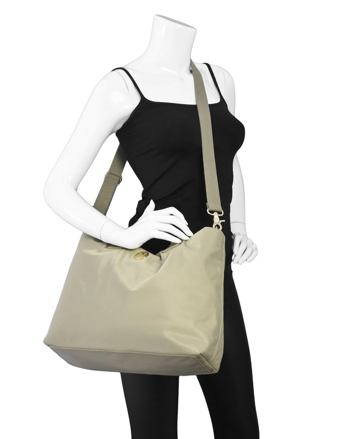 Tory Burch Beige Nylon Dene Bag

Made In: China
Color: Beige
Hardware: Goldtone
Materials: Nylon
Lining: Beige textile
Closure/Opening: Center magnetic snap
Exterior Pockets: None
Interior Pockets: One zipper pocket and two patch pocket
Retail