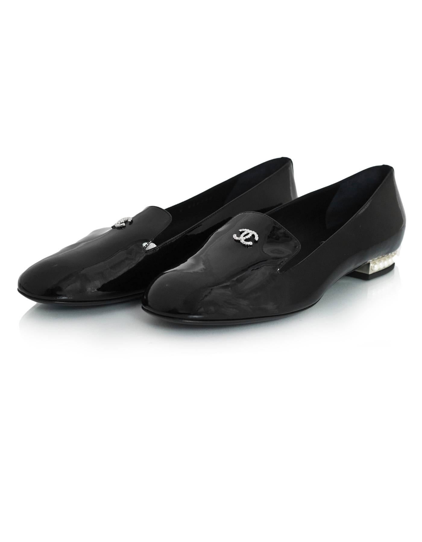 Chanel Black Patent CC Loafers Sz 39 NEW
Features pave crystal CC at tongue and pearl detail at heels

Made In: Italy
Color: Black
Materials: Patent leather
Closure/Opening: Slide on
Sole Stamp: CC Made in Italy 39
Retail Price: $1,075 + tax
Overall