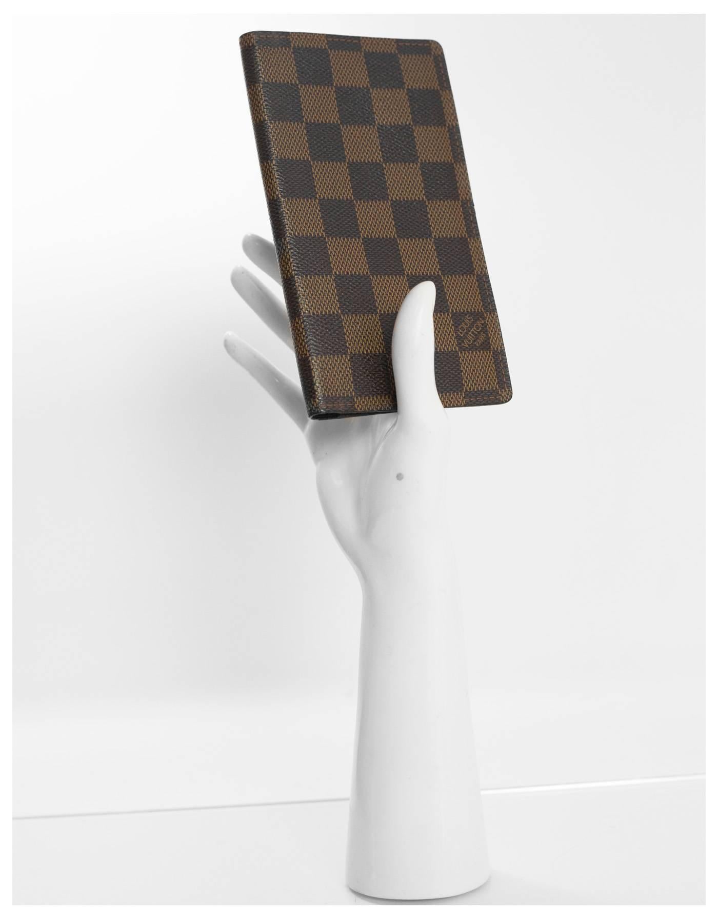 Louis Vuitton Damier Checkbook Cover

Made In: Spain
Year of Production: 2001
Color: Brown
Hardware: None
Materials: Coated Canvas
Lining: Brown coated canvas
Closure/Opening: Bi-fold
Exterior Pockets: None
Interior Pockets: Three slit card