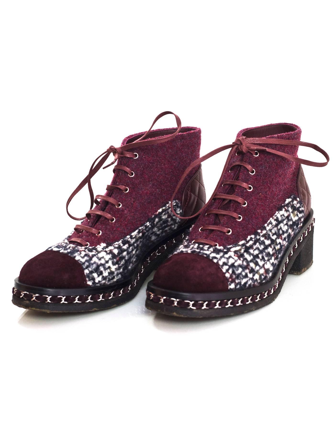 Chanel Burgundy, Black & White Tweed Boots Sz 39
Features chain around detail at soles

Made In: Italy
Color: Burgundy, black and white
Materials: Suede and tweed
Closure/Opening: Lace tie closure
Sole Stamp: CC 39
Overall Condition: Excellent