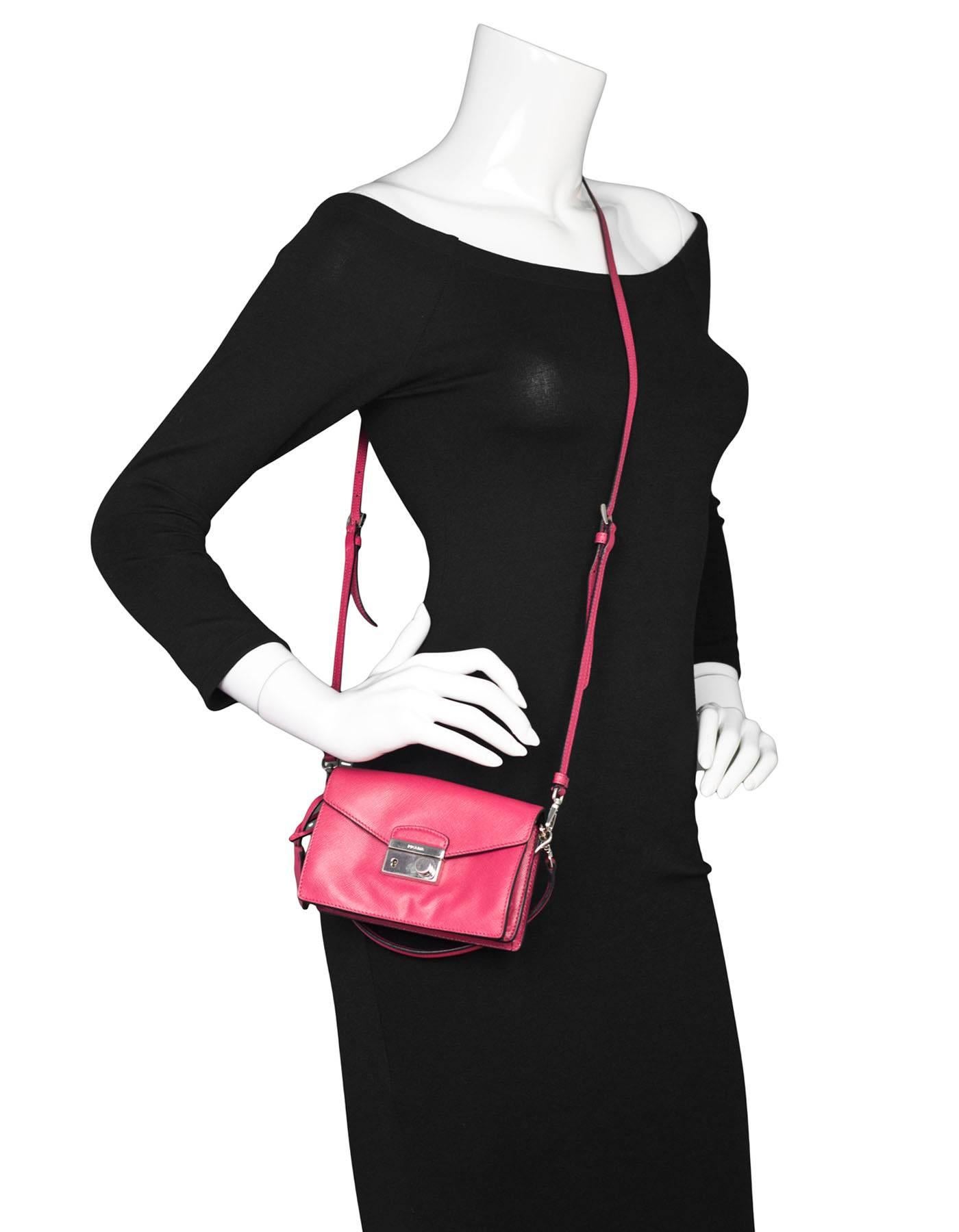 Prada Salmon Pink Saffiano Mini Sound Crossbody Bag
Features interchangable crossbody strap or handle strap

Made In: Italy
Color: Salmon pink
Materials: Saffiano leather, metal
Lining: Black leather
Closure/Opening: Flap top with push lock
Exterior