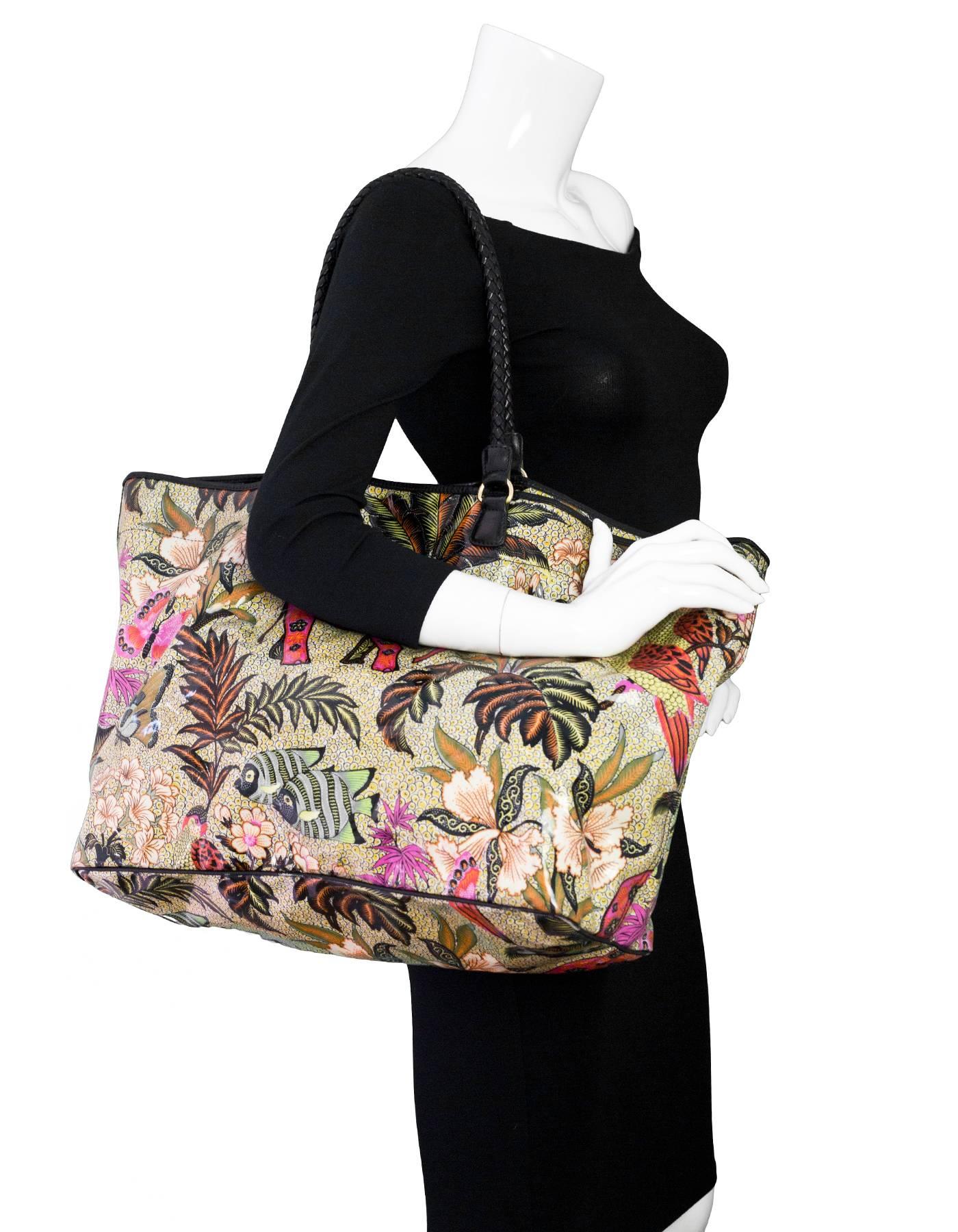 Etro Jungle Print PVC Beach Tote

Made In: Italy
Color: Multi
Materials: PVC, Leather
Lining: Thin canvas
Closure/Opening: Open top with center snap button
Exterior Pockets: None
Interior Pockets: attached zip pochette
Overall Condition: Excellent