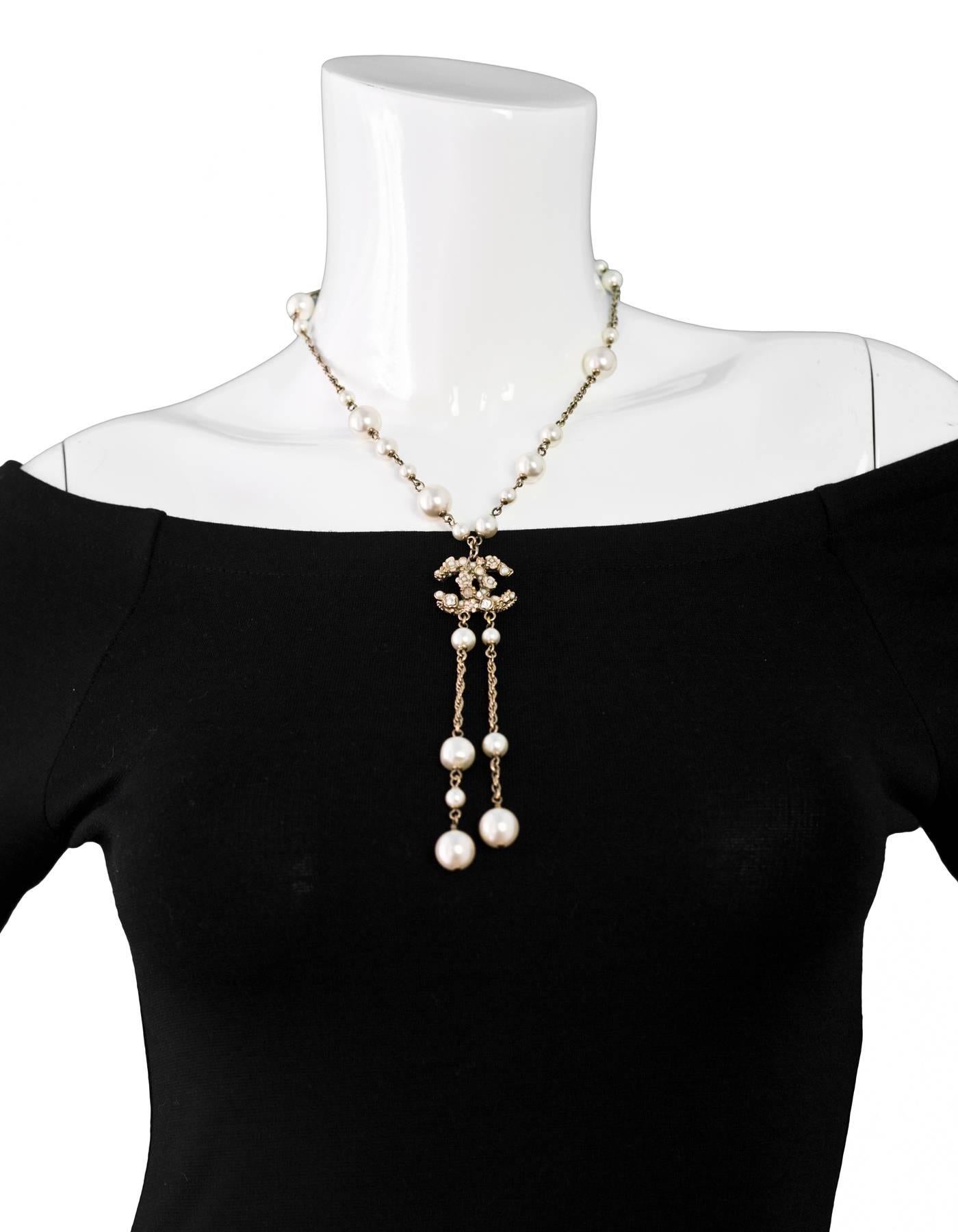 Chanel Pearl Lariat Necklace
Features floral detail at CC

Made In: Italy
Year of Production: 2011
Color: Light goldtone, ivory, pink
Materials: Metal, faux pearl, enamel
Closure: Lobster clasp
Stamp: Chanel B11 CC A Made In Italy
Overall Condition: