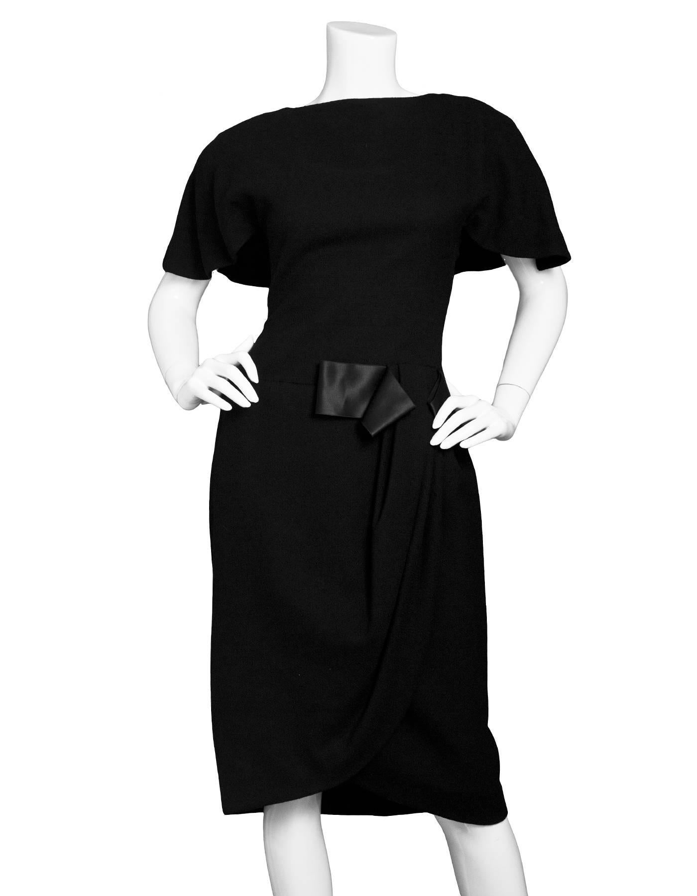 Scassi Vintage Black Flutter Sleeve Wool Dress
Features gathering and bow at waist and cape style back with button down closure at neckline

Made In: USA
Color: Black
Composition: Believed to be a wool-blend
Lining: Black, silk