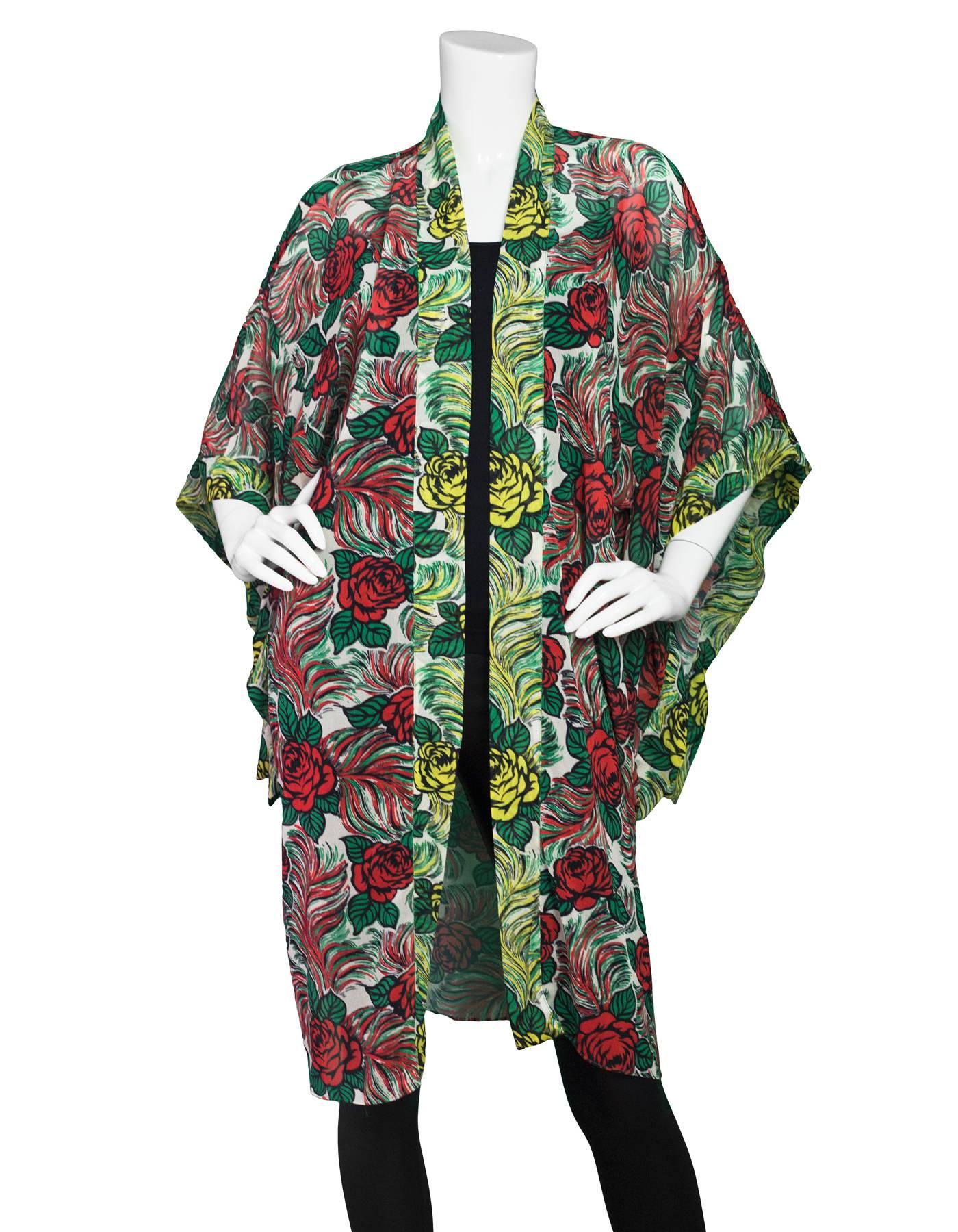 Anna Sui Floral Print Silk Kimono
Features slits on undersides of sleeves 

Color: Black, red, green and white
Composition: Not given- believed to 100% silk
Lining: None
Closure/Opening: Open front
Exterior Pockets: None
Interior Pockets: