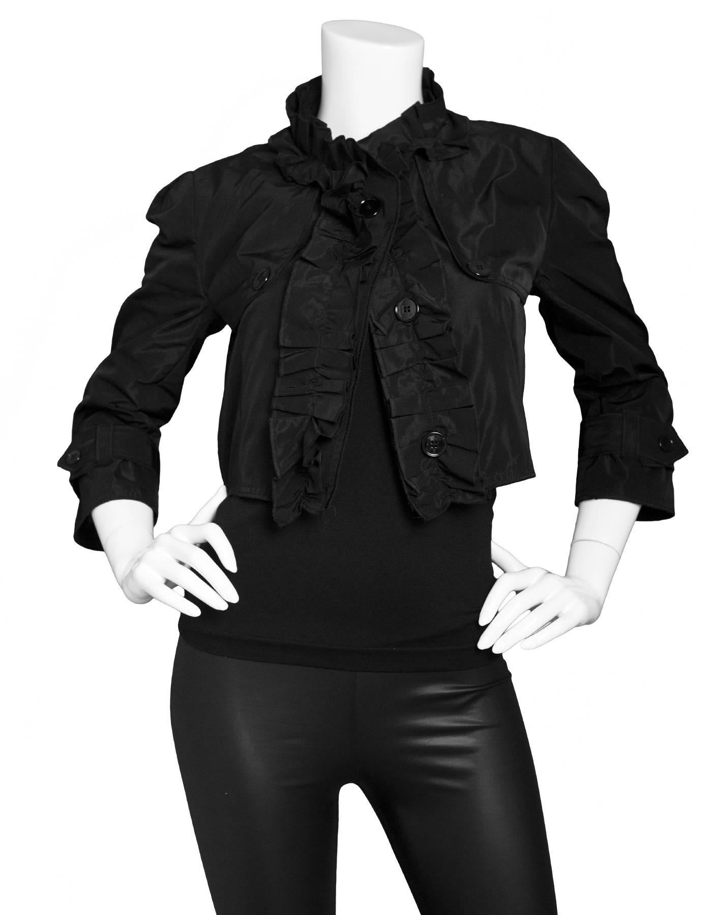 Dolce & Gabbana Black Cropped Jacket 
Features ruffle detail at neckline and down jacket opening

Made In: Italy
Color: Black
Composition: 100% polyester
Lining: Black, 100% silk
Closure/Opening: Button down front closure
Exterior Pockets: