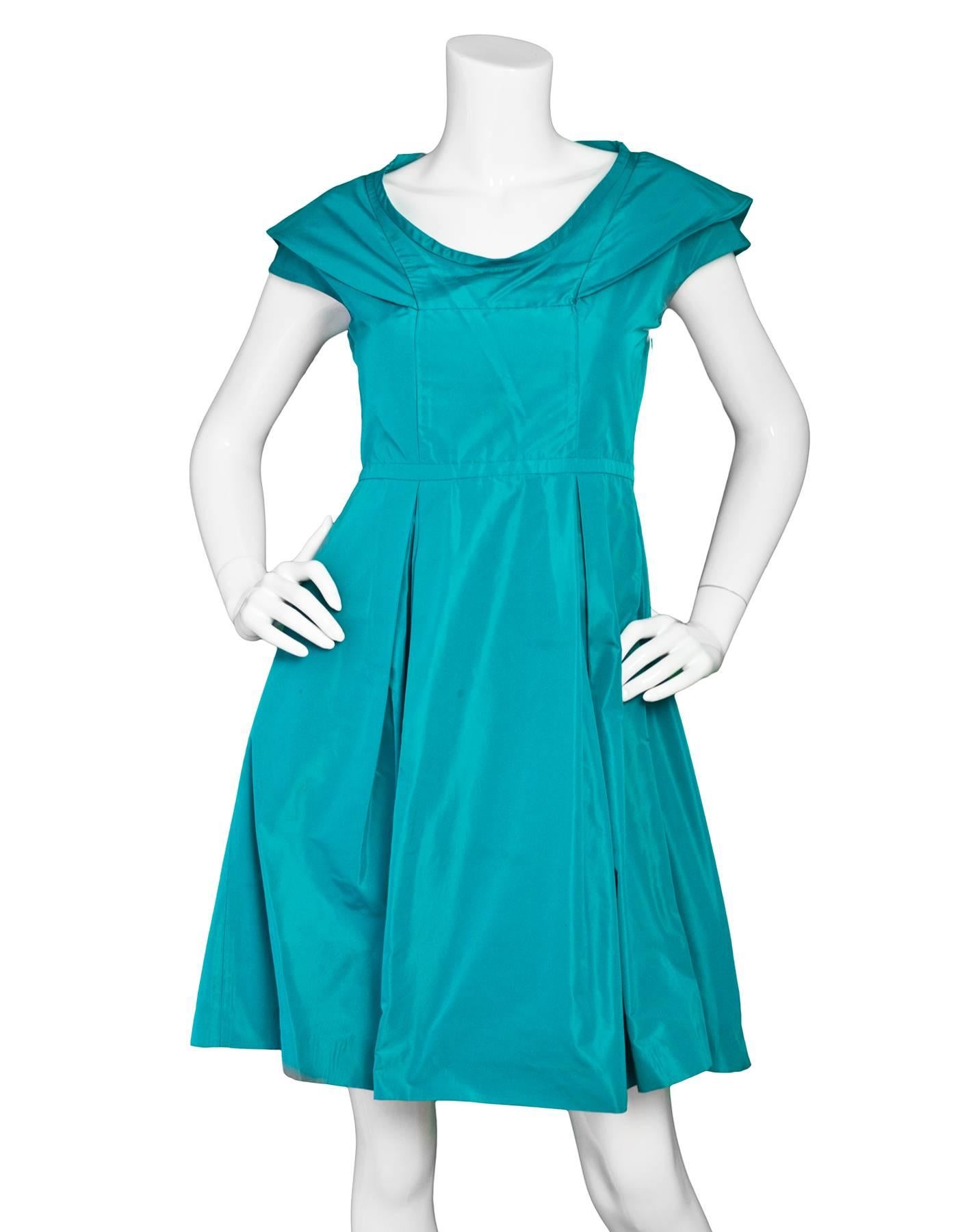 Miu Miu Turquoise Taffeta Pleated Dress 

Made In: Italy
Color: Turquoise
Composition: 55% Polyester, 45% Acetate
Lining: None
Closure/Opening: Side zip closure
Exterior Pockets: Two hip pockets
Interior Pockets: None
Overall Condition: Excellent