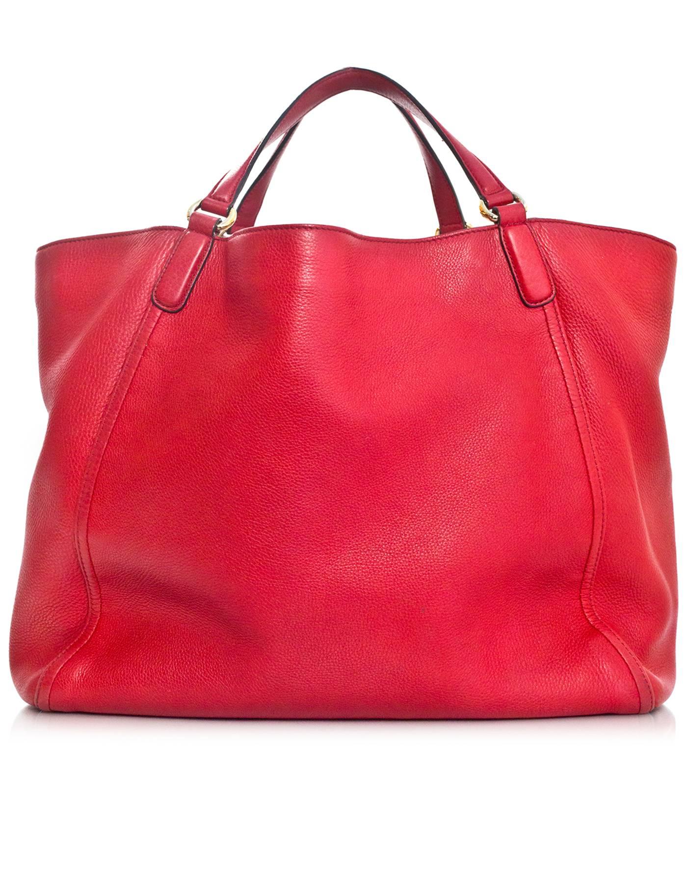 Gucci Red Leather Soho Tote Bag 
Features GG logo stitched at front and optional tassel charm

Made In: Italy
Color: Red
Hardware: Light goldtone
Materials: Leather
Lining: Beige canvas
Closure/Opening: Open with lobster hook at side 
Exterior