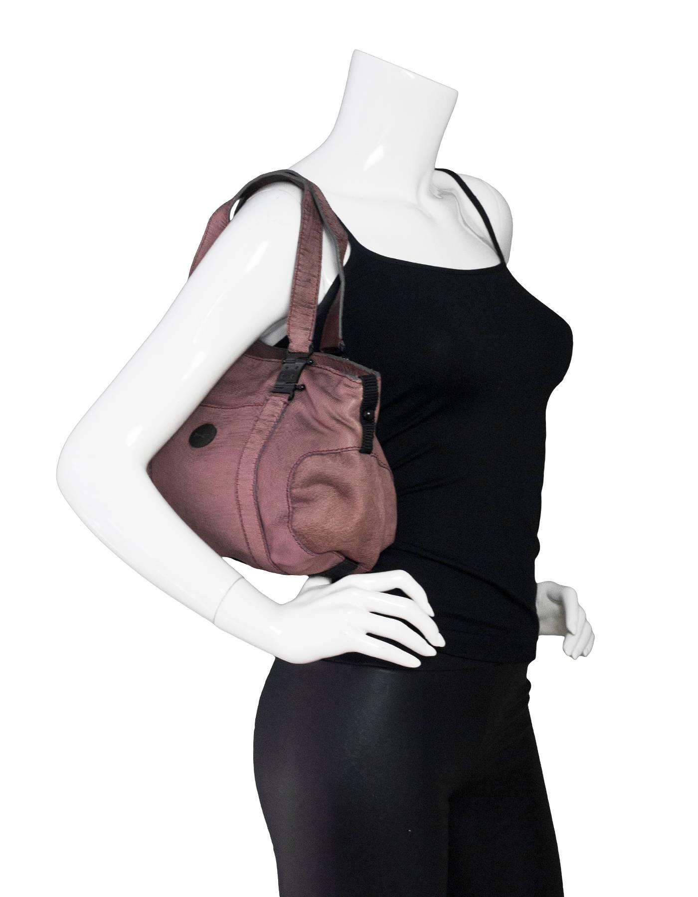 Rochas Mauve Layered Leather Bag

Made In: Italy
Color: Mauve
Hardware: Black
Materials: Leather
Lining: Black textile
Closure/Opening: Zip top
Exterior Pockets: None
Interior Pockets: One zipper pocket 
Overall Condition: Excellent pre-owned