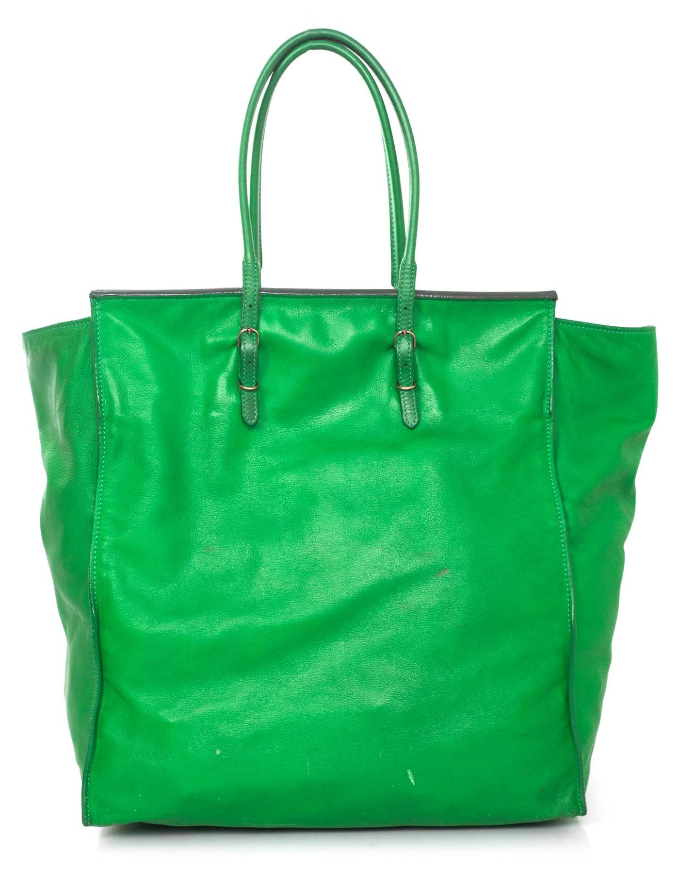 Balenciaga Green Leather Papier Ledger Tote
Features attached small mirror to front zipper pocket

Made In: Italy
Color: Green
Hardware: Bronze
Materials: Leather
Lining: Green suede
Closure/Opening: Open top
Exterior Pockets: One front zipper