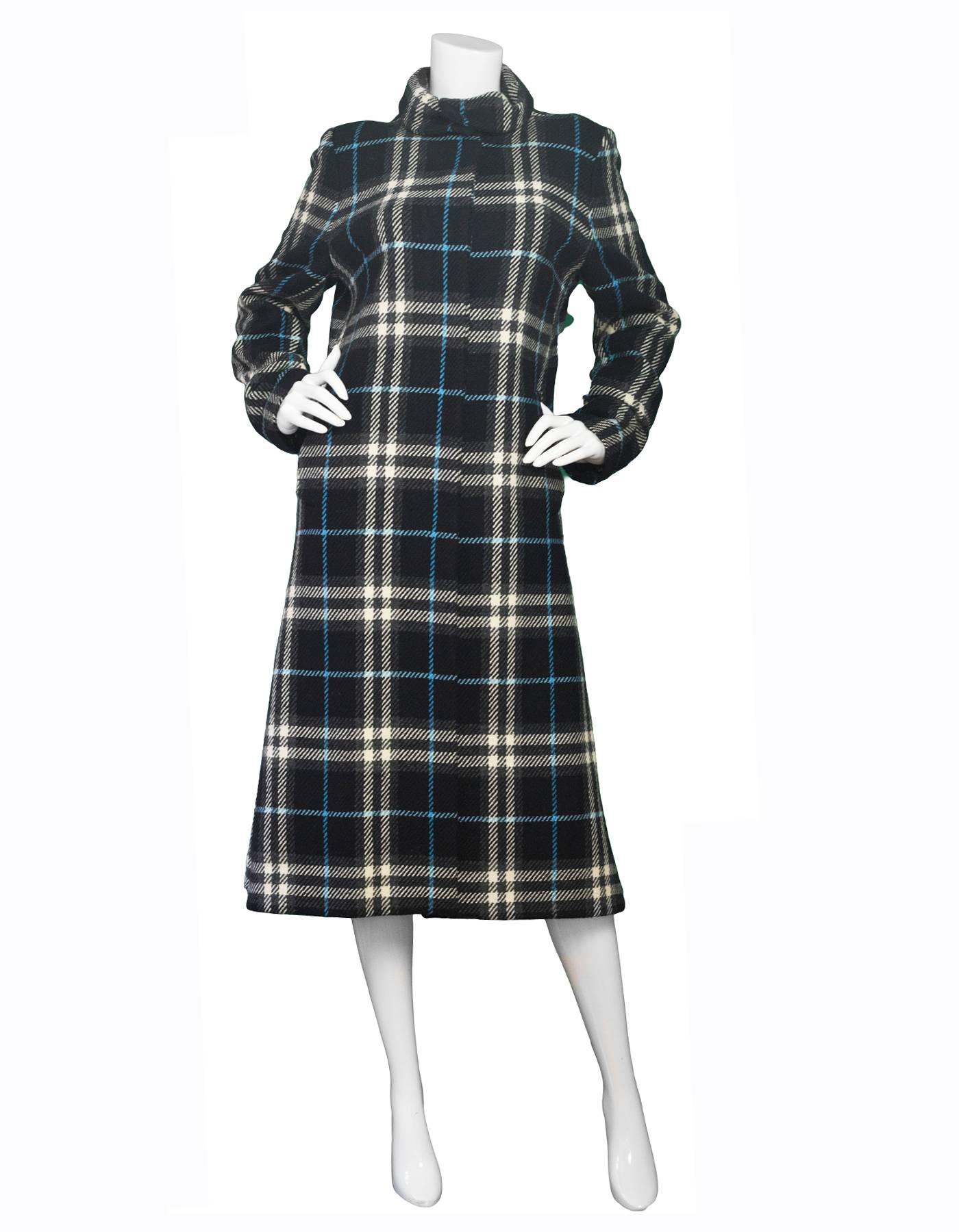 Burberry London Black & Blue Plaid Long Peacoat 

Made In: Italy
Color: Black, blue, white and grey
Composition: 100% lambswool
Lining: Black, 100% rayon viscose 
Closure/Opening: Center button up closure
Exterior Pockets: Two hip