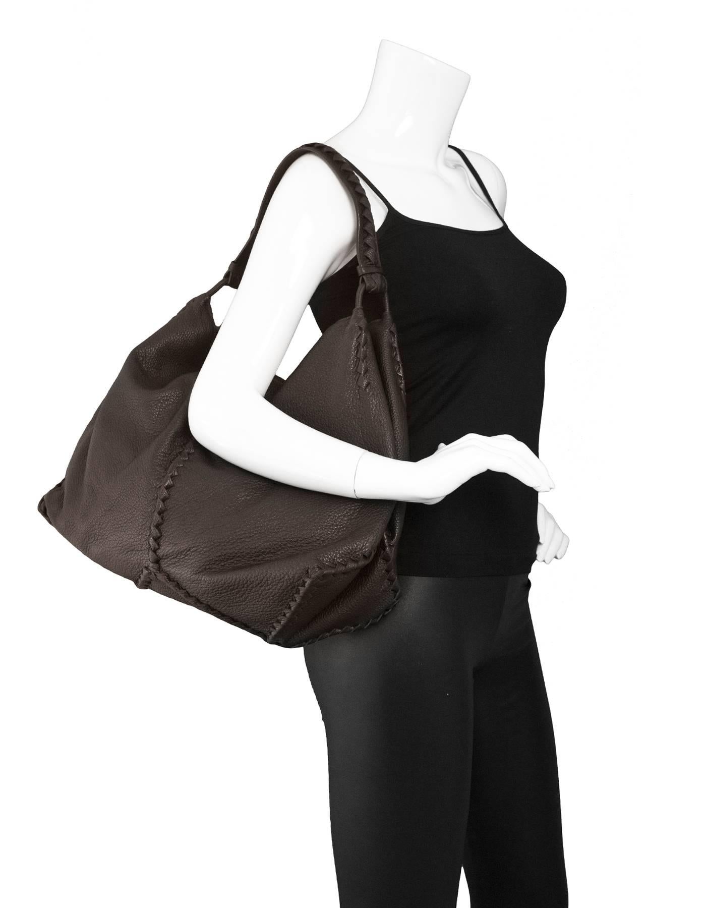 Bottega Veneta Brown Leather Deerskin Hobo Bag

Made In: Italy
Color: Brown
Hardware: None
Materials: Deerskin leather
Lining: Taupe suede
Closure/Opening: Open top
Exterior Pockets: None
Interior Pockets: One zip pocket and one small wall