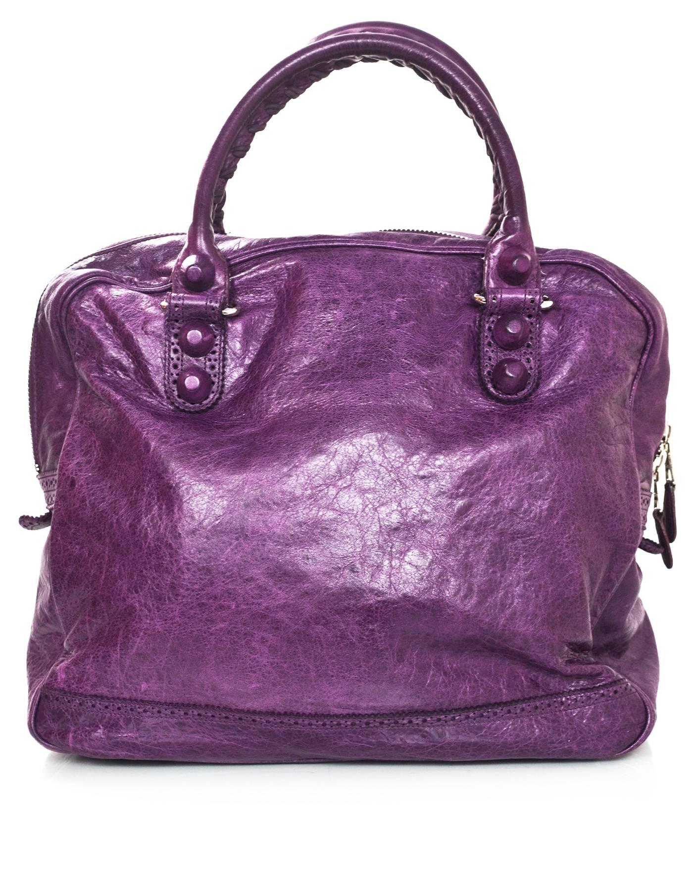 Balenciaga Purple Agneau Lambskin Covered Giant Brogues Office Bag 
Features purple leather covered grommets

Made In: Italy
Color: Purple
Hardware: Silvertone
Materials: Distressed leather
Lining: Black canvas
Closure/Opening: Zip across