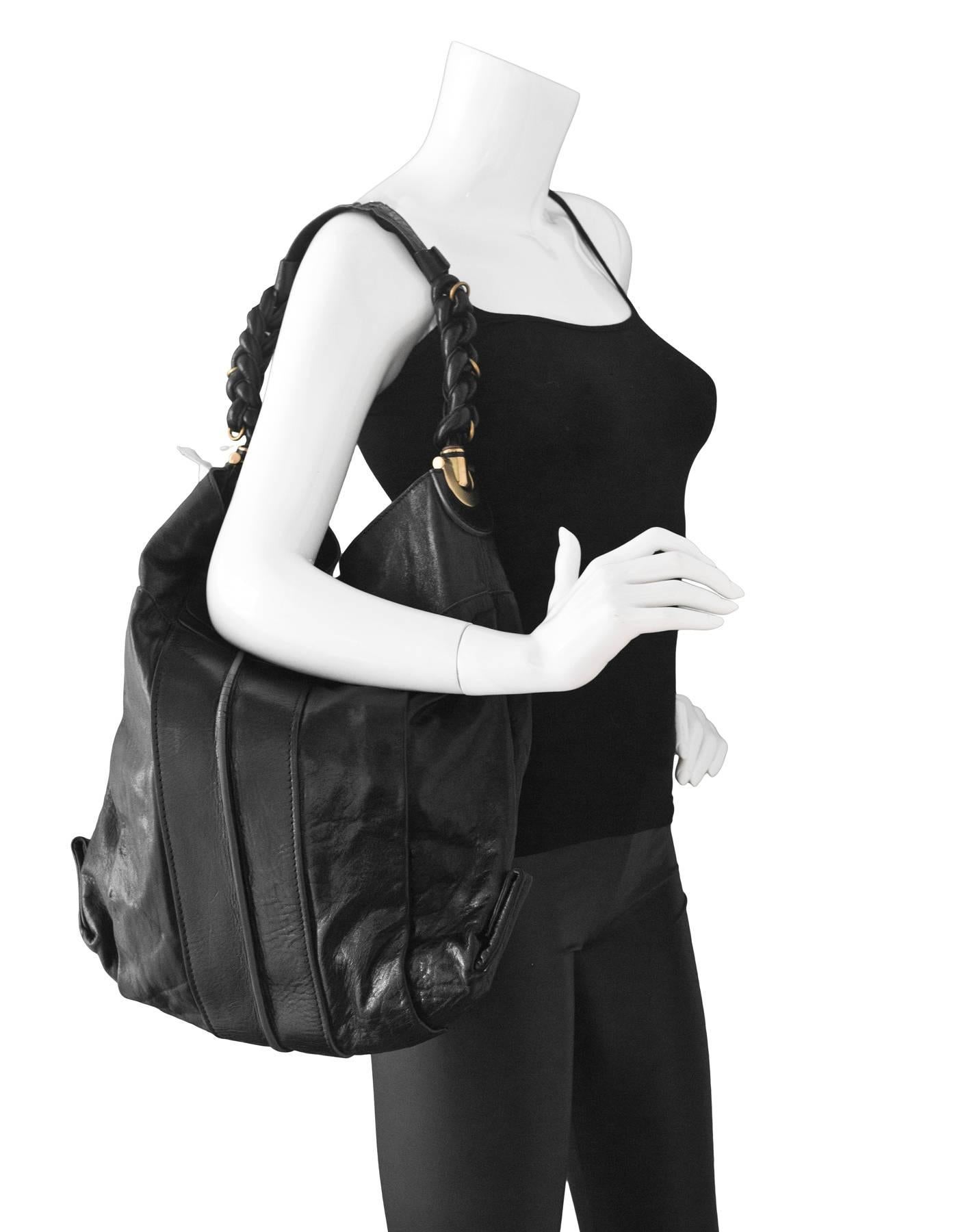 Chloe Black Leather Hobo

Made In: Italy
Color: Black
Hardware: Goldtone
Materials: Leather
Lining: Beige textile
Closure/Opening: Zip top with center snap
Exterior Pockets: Small snap card compartment
Interior Pockets: One wall pocket, one zip