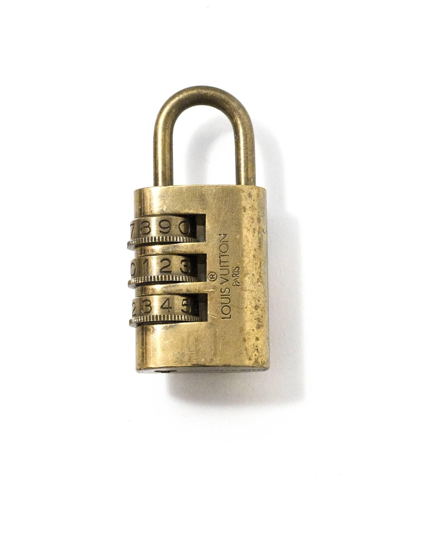 Louis Vuitton Vintage Brass Combination Lock

Made In: France
Color: Gold
Hardware: Brass
Materials: Metal
Stamp: Louis Vuiton Paris Made in France
Overall Condition: Very good good pre-owned condition, light tarnish throughout

Measurements: 
Lock: