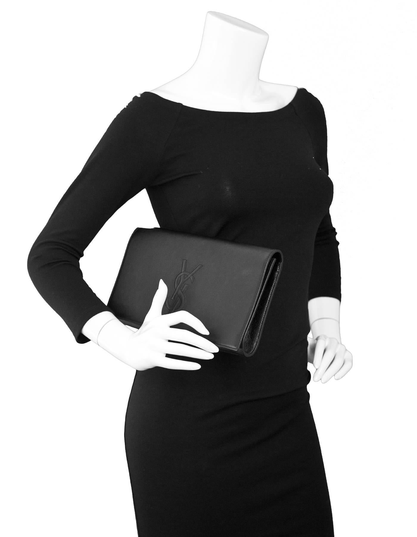 Yves Saint Laurent Black Leather Large Belle De Jour Clutch

Made In: Italy
Color: Black
Materials: Calfskin leather 
Lining: Black textile
Closure/Opening: Flap top with snap closure
Exterior Pockets: None
Interior Pockets: One small patch
