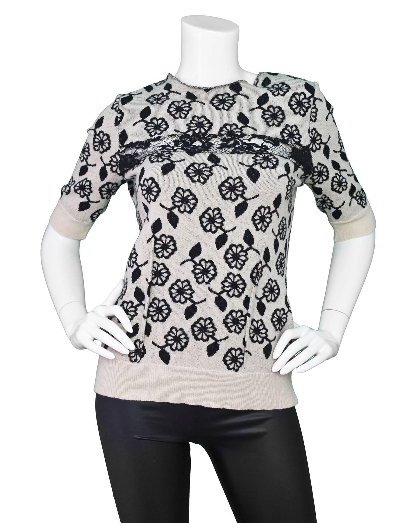 Nina Ricci Black & White Cashmere Short Sleeve Sweater
Features black lace detail at bustline

Made In: France
Color: Black and white
Composition: 92% wool, 8% cashmere
Lining: None
Closure/Opening: Pull over
Exterior Pockets: None
Interior 