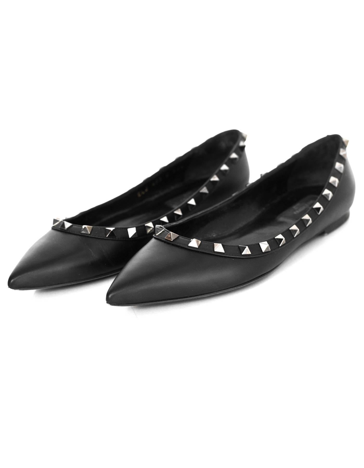 Valentino Noir Rockstud Flats Sz 37.5

Made In: Italy
Color: Black
Retail Price: $775 + tax
Materials: Leather, metal
Closure/Opening: Slide on
Sole Stamp: Valentino Garavani Made in Italy 37.5
Overall Condition: Excellent pre-owned condition with