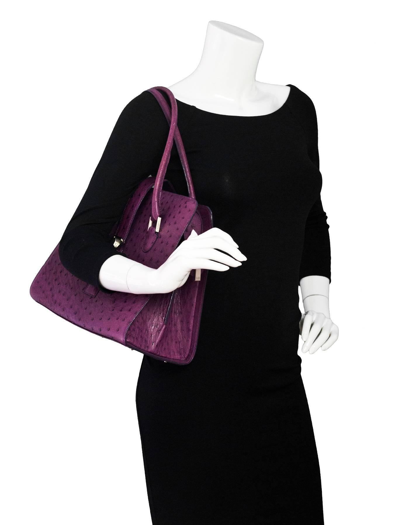 Manolo Blahnik Purple Purple Ostrich Tote

Color: Purple
Materials: Ostrich leather, metal
Lining: Olive green textile
Closure/Opening: Zip top closure with center strap and buckle
Exterior Pockets: None
Interior Pockets: Two patch pockets, small