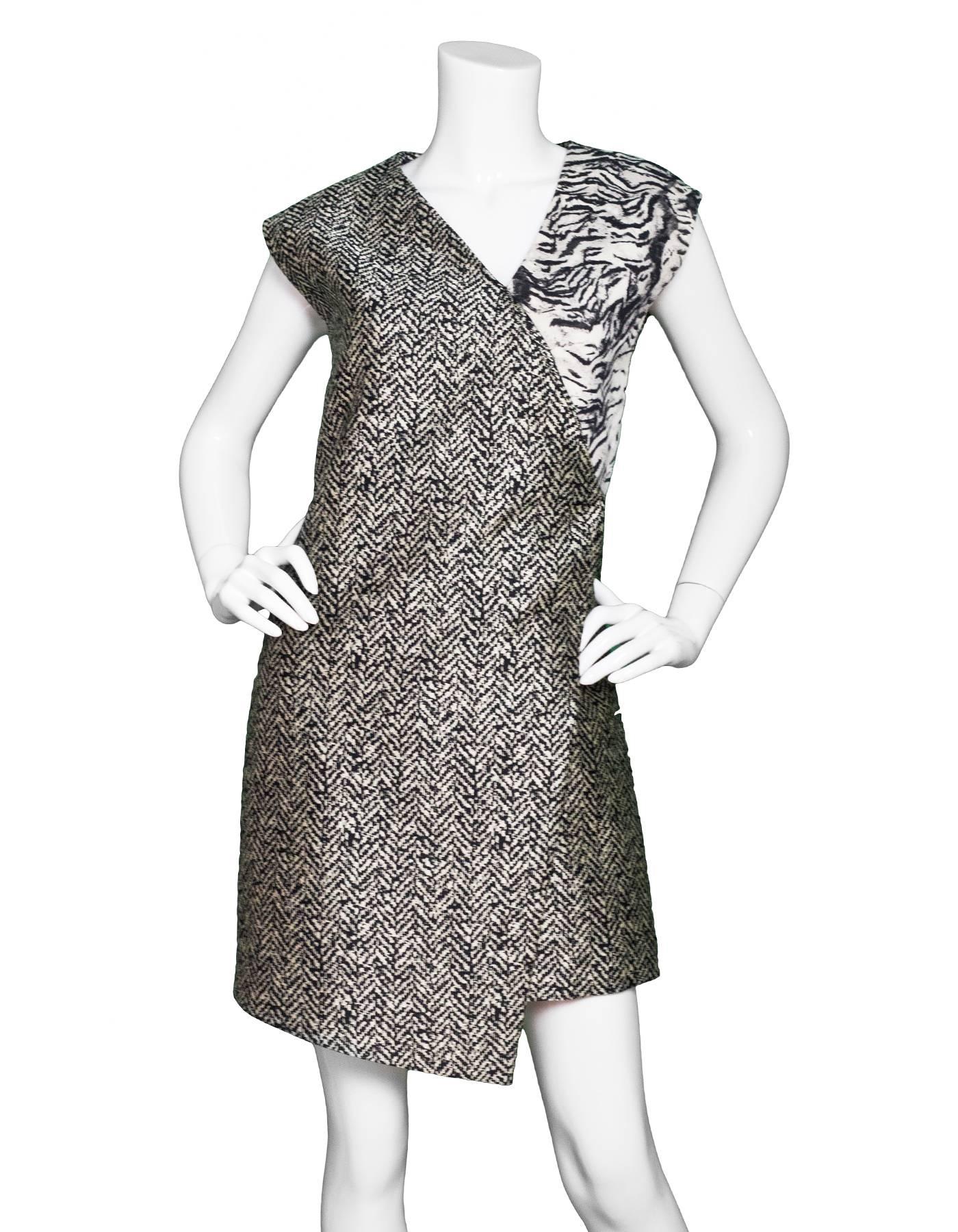 Emanuel Ungaro Print Sleeveless Dress Sz 4
Features heringbone print throughout and faux wrap-style at front

Made In: Italy
Color: Black, grey
Composition: 83% polyester, 17% silk
Lining: Black, nylon-blend
Closure/Opening: Back zip