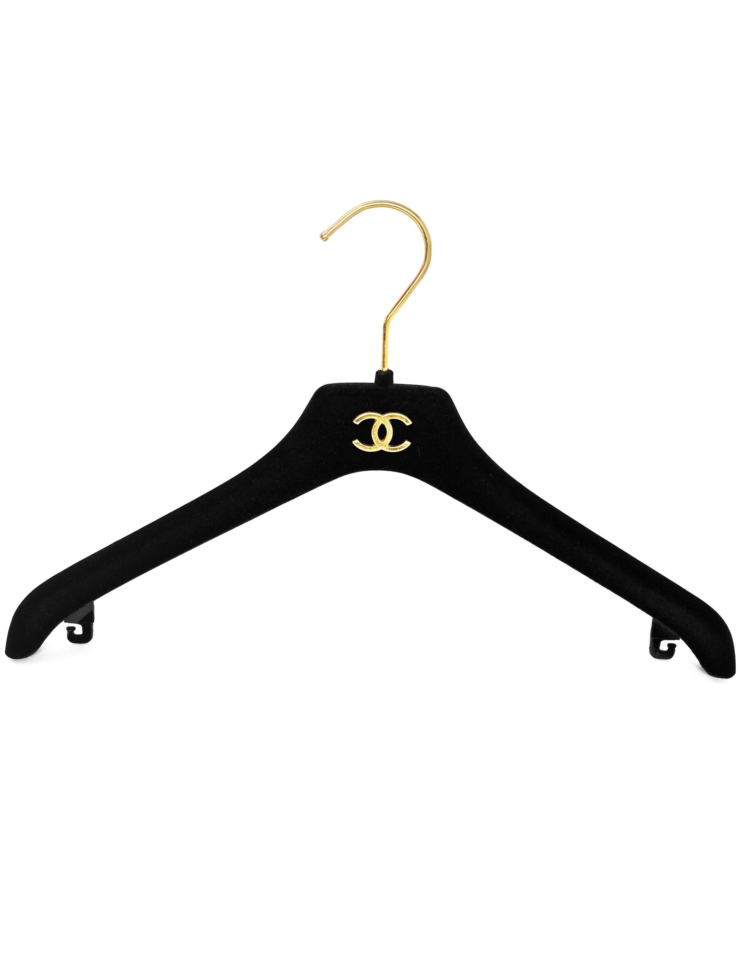 Chanel Black Velvet Coat Hangers- Set of 4 
Features goldtone CC emblem on hanger- Comes with 4 jacket hangers

Color: Black
Materials: Metal, velvet and resin
Overall Condition: Excellent pre-owned condition light tarnish at hardware
Includes: Four
