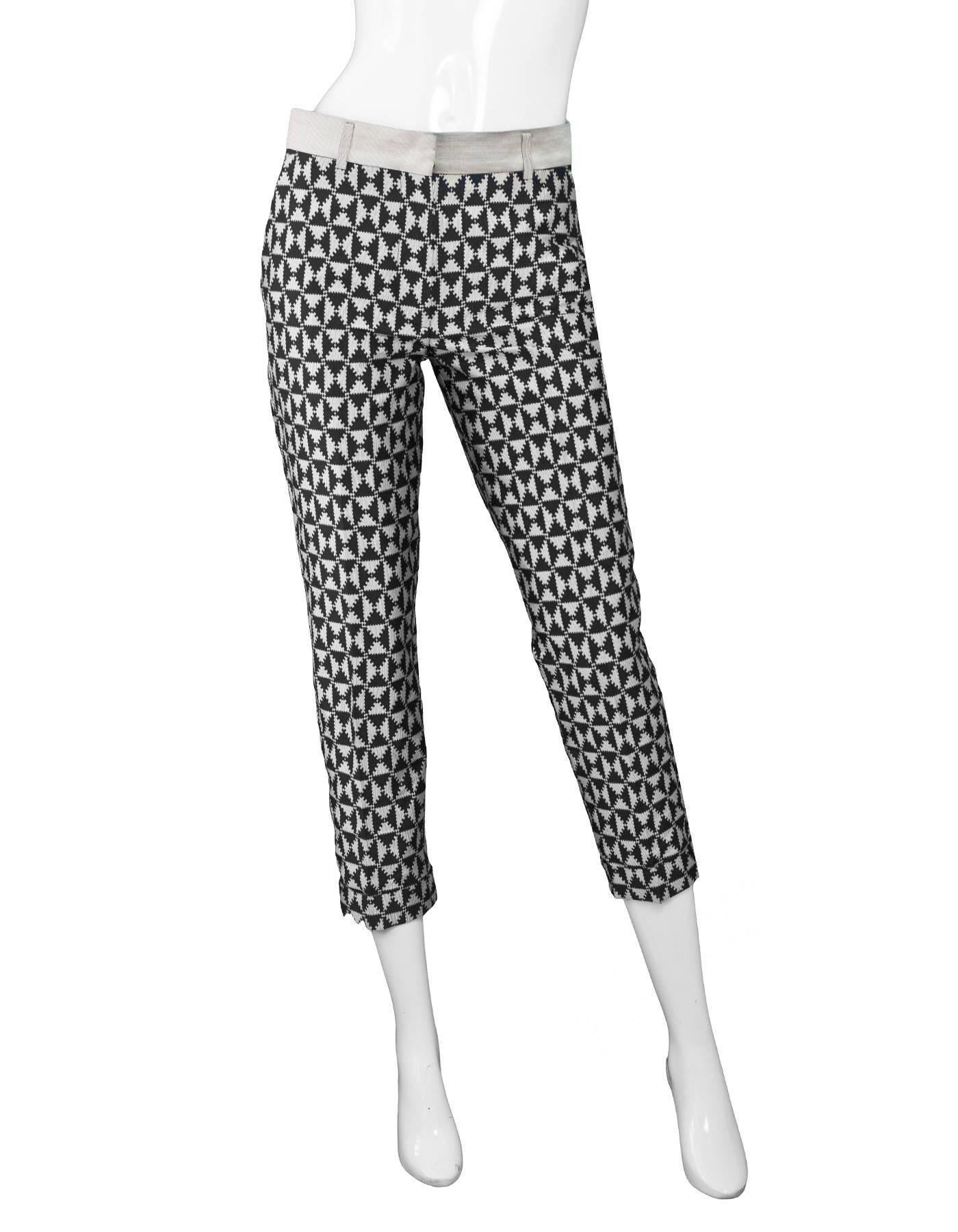 Haider Ackermann Black and Silver Print Pants Sz FR34

Made In: Romania
Color: Black, silver
Composition: 100% polyester
Lining: None
Closure/Opening: Front zip and hook and eye closure
Exterior Pockets: Two hip pockets and two back faux