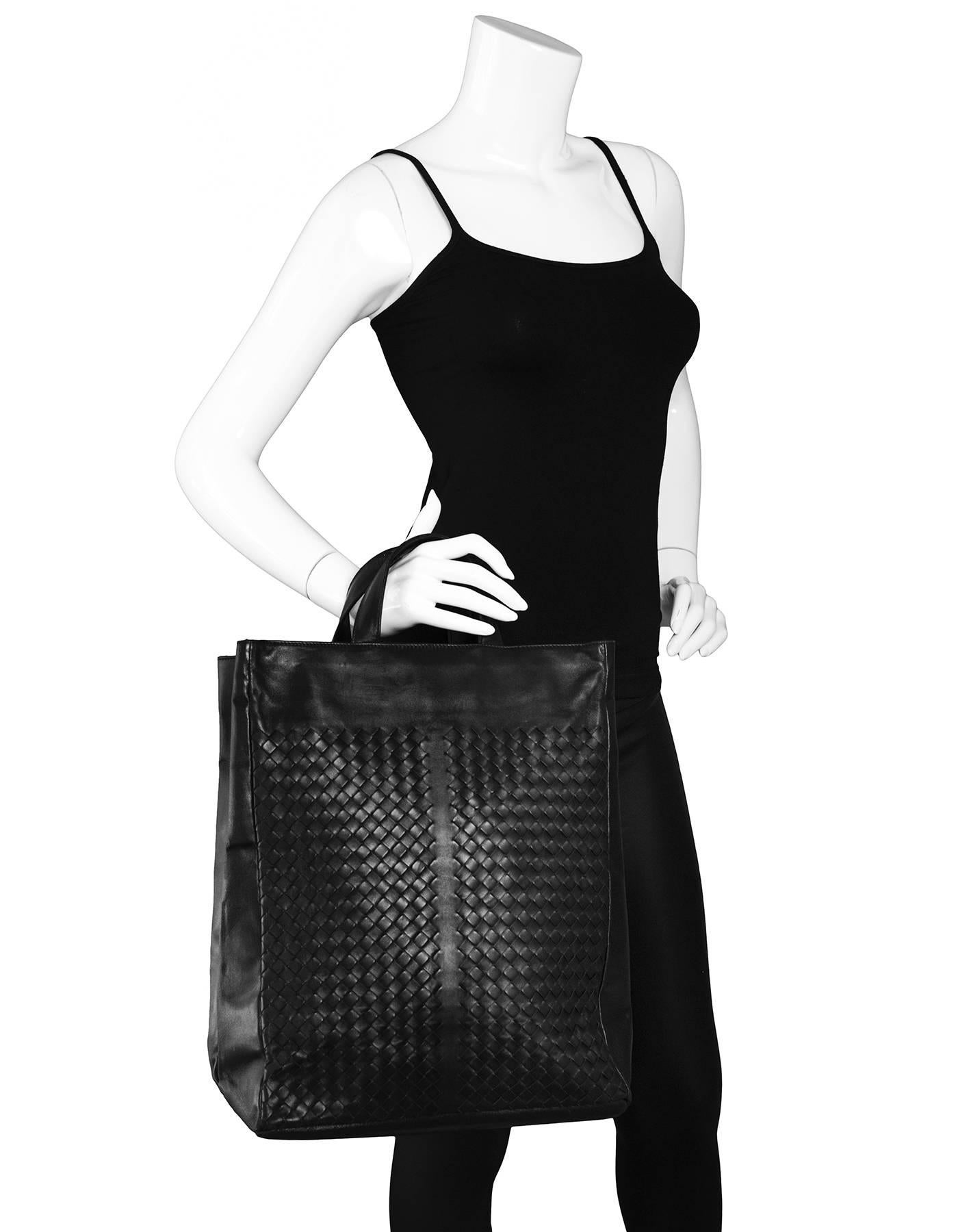 Bottega Veneta Black Intrecciato Tote

Made In: Italy
Color: Black
Hardware: None
Materials: Leather
Lining: Beige textile
Closure/Opening: Open top
Exterior Pockets: None
Interior Pockets: Zip pocket, small phone pocket
Overall Condition: Excellent