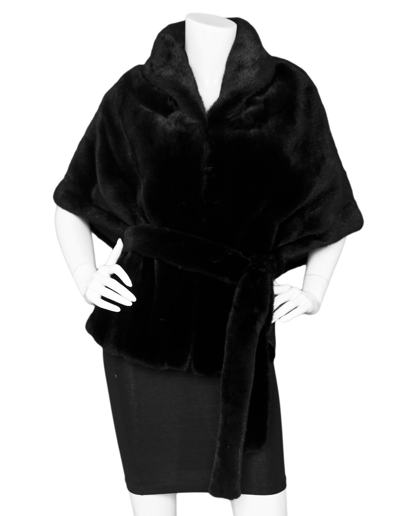 Sagafur Black Mink Cape with Belt

Features draped lapels

Color: Black
Composition: Believed to be mink fur
Lining: Black textile
Closure/Opening: Front hook and eye closure
Retail Price: $2,600 + tax
Overall Condition: Excellent pre-owned