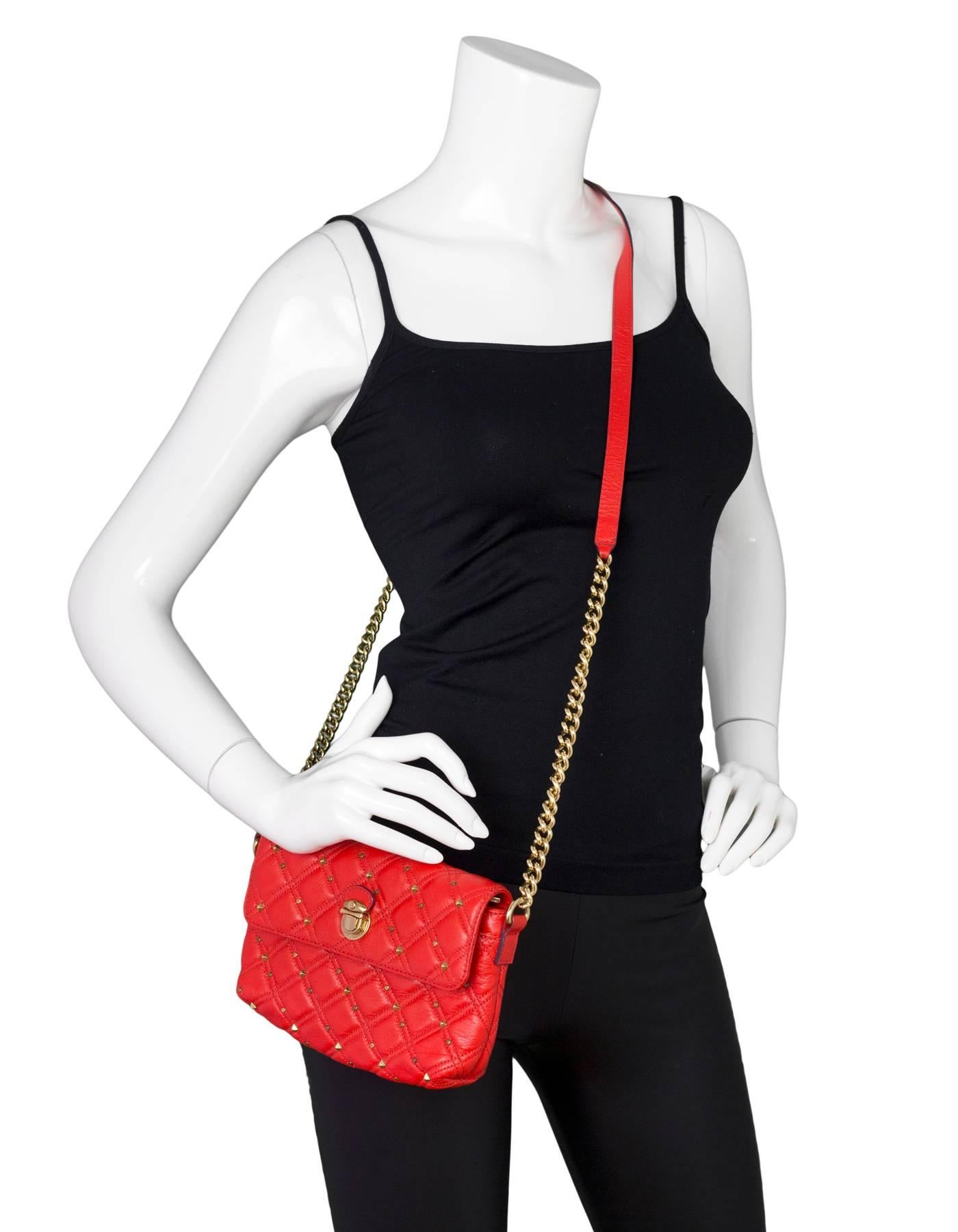 Marc Jacobs Red Leather Studded Crossbody Bag

Made In: Italy
Color: Red
Hardware: Goldtone
Materials: Leather, metal
Lining: Grey textile
Closure/Opening: Flap top with snap closure
Exterior Pockets: None
Interior Pockets: One compartment, zip