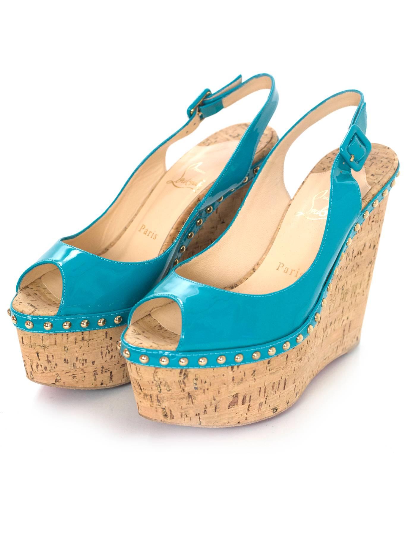 Christian Louboutin Turquoise Patent Leather Peep-Toe Wedges Sz 38
Features studding detail

Made In: Italy
Color: Turquoise, tan
Materials: Patent leather, cork
Closure/Opening: Slingback strap
Sole Stamp: Christian Louboutin MADE IN ITALY