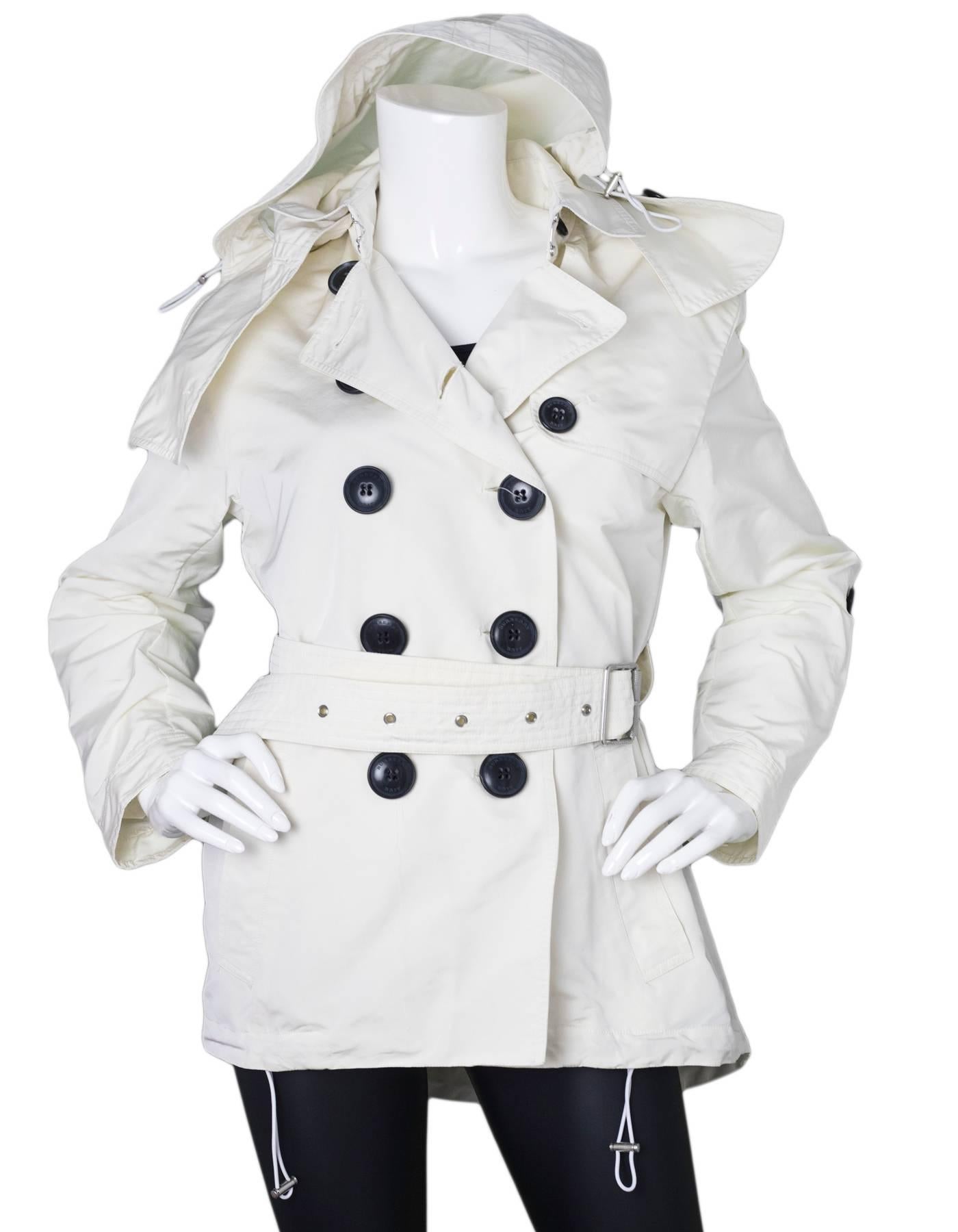 Burberry Brit Cream Knightsdale Hooded Trench Coat Sz 4

Made In: Italy
Color: Cream
Composition: 100% Polyester
Lining: None
Closure/Opening: Front double breast button closure
Exterior Pockets: Two hip pockets
Overall Condition: Excellent